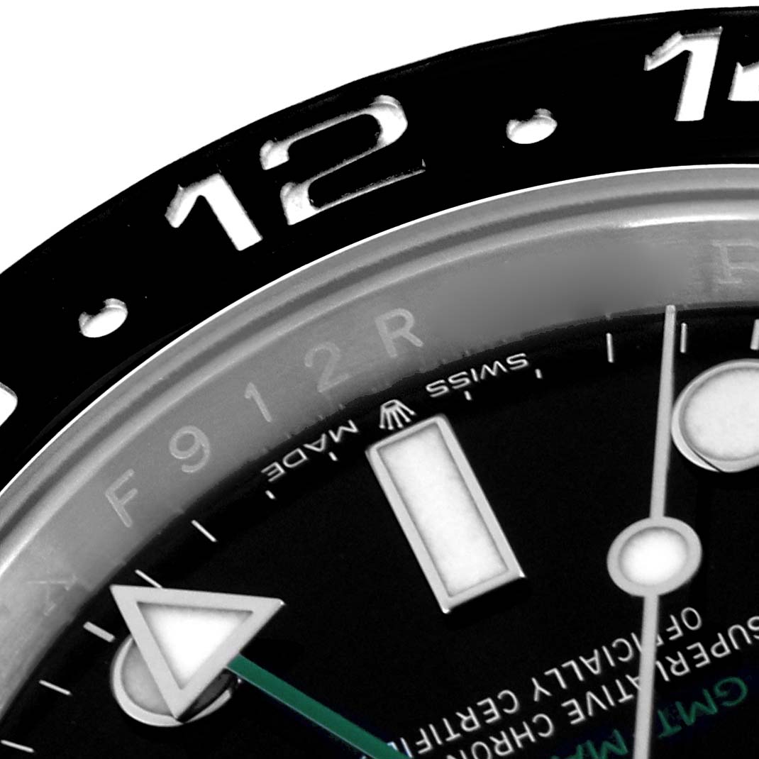 The image shows a close-up of the Rolex GMT-Master 126710 Men
s Stainless Steel Black Dial 126710 Men
s Stainless Steel Black Dial
s bezel, hour marker, and watch hands, viewed at an angled top perspective.