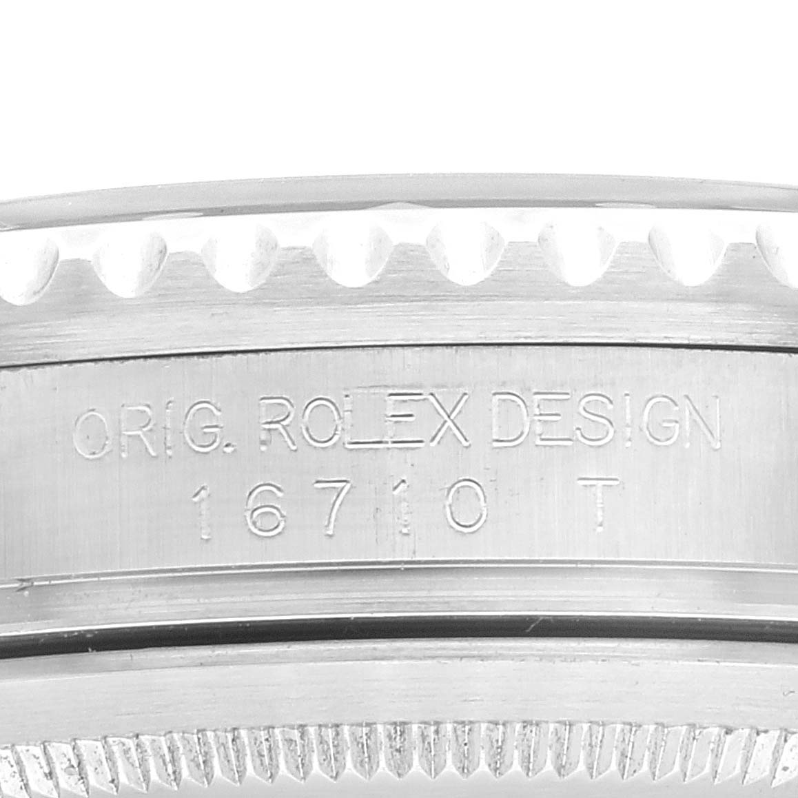 The image shows a close-up view of the side of a Rolex Date 16710 Men's Stainless Steel Black Dial 16710 Men's Stainless Steel Black Dial model watch casing engraved with "ORIG. ROLEX DESIGN 16710 T".