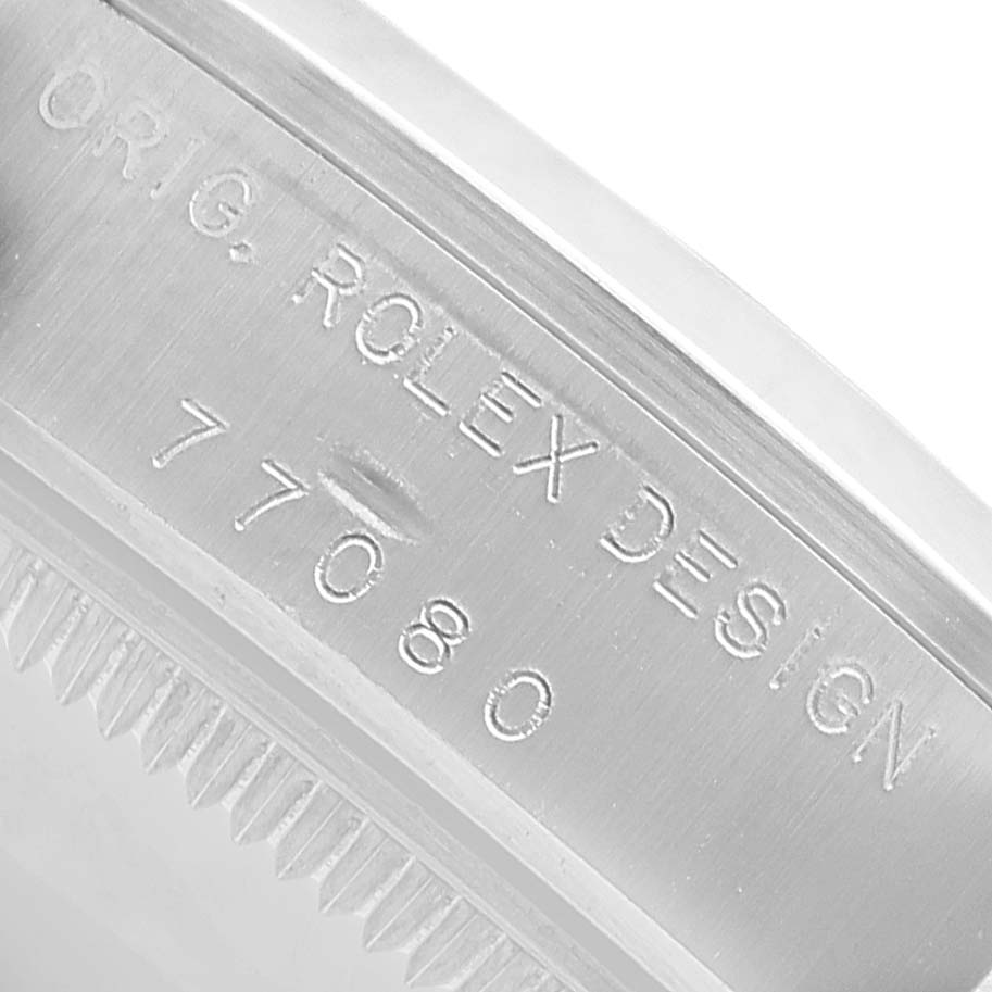 The image shows the side engraving of a Rolex Mid-Size 77080 Women's Stainless Steel Blue Dial model, highlighting the model number and "ORIG. ROLEX DESIGN".