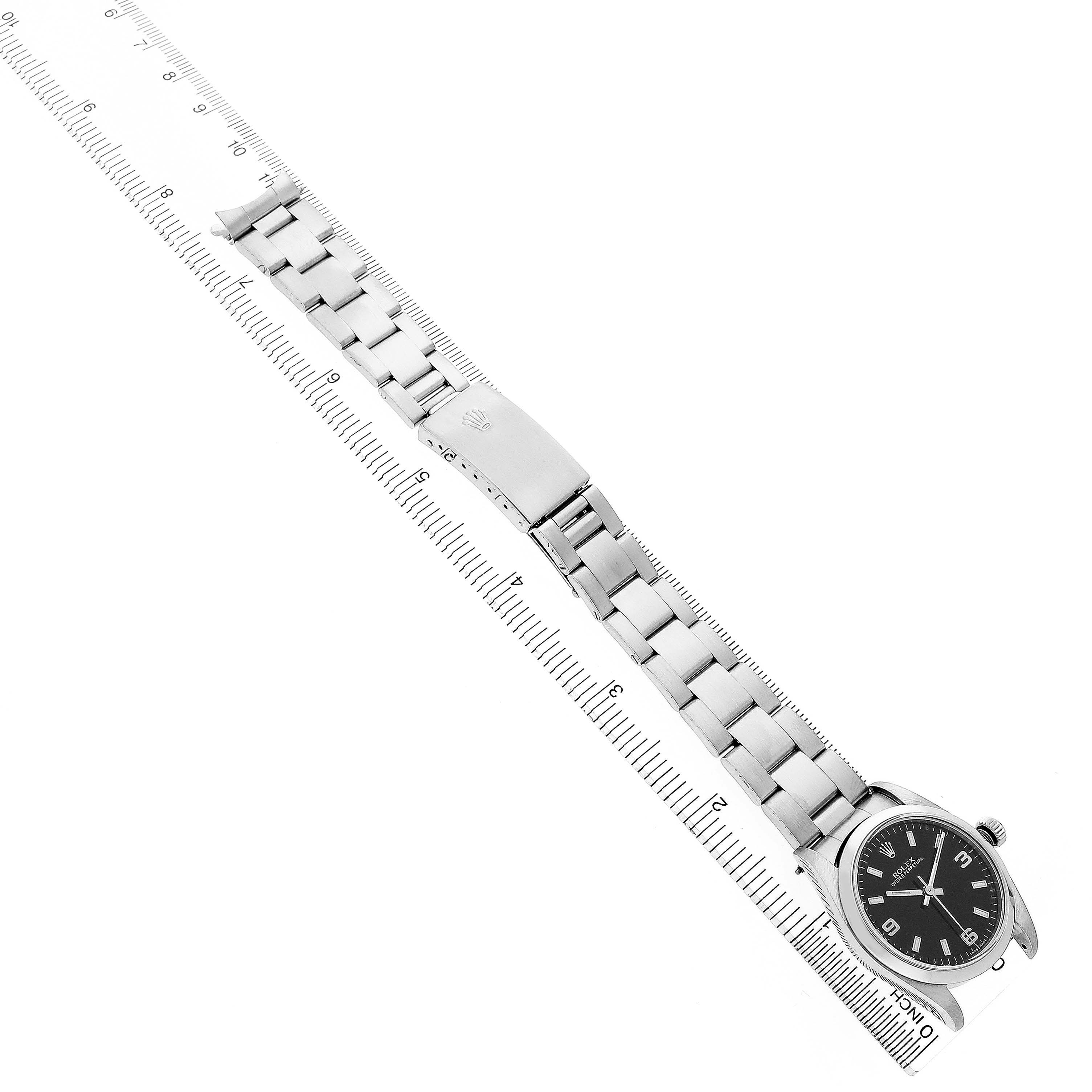 The image shows the Rolex Oyster Perpetual 77080 Women's Stainless Steel Black Dial watch laid flat, displaying the full bracelet and black dial.
