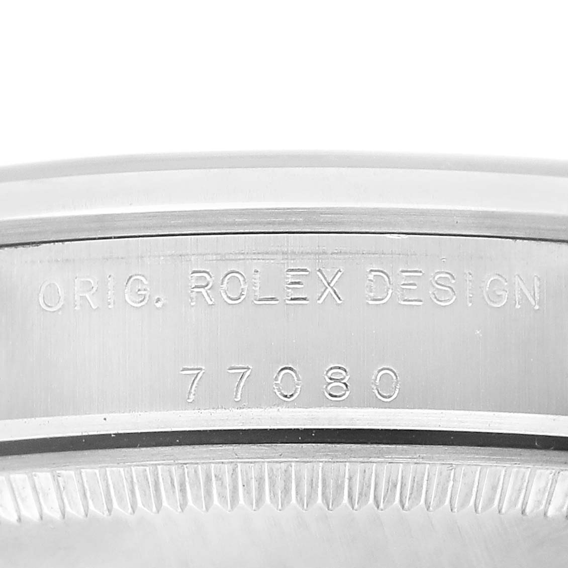 The image shows a close-up of the case side of the Rolex Oyster Perpetual 77080 Women's Stainless Steel Black Dial, featuring engraved model details.