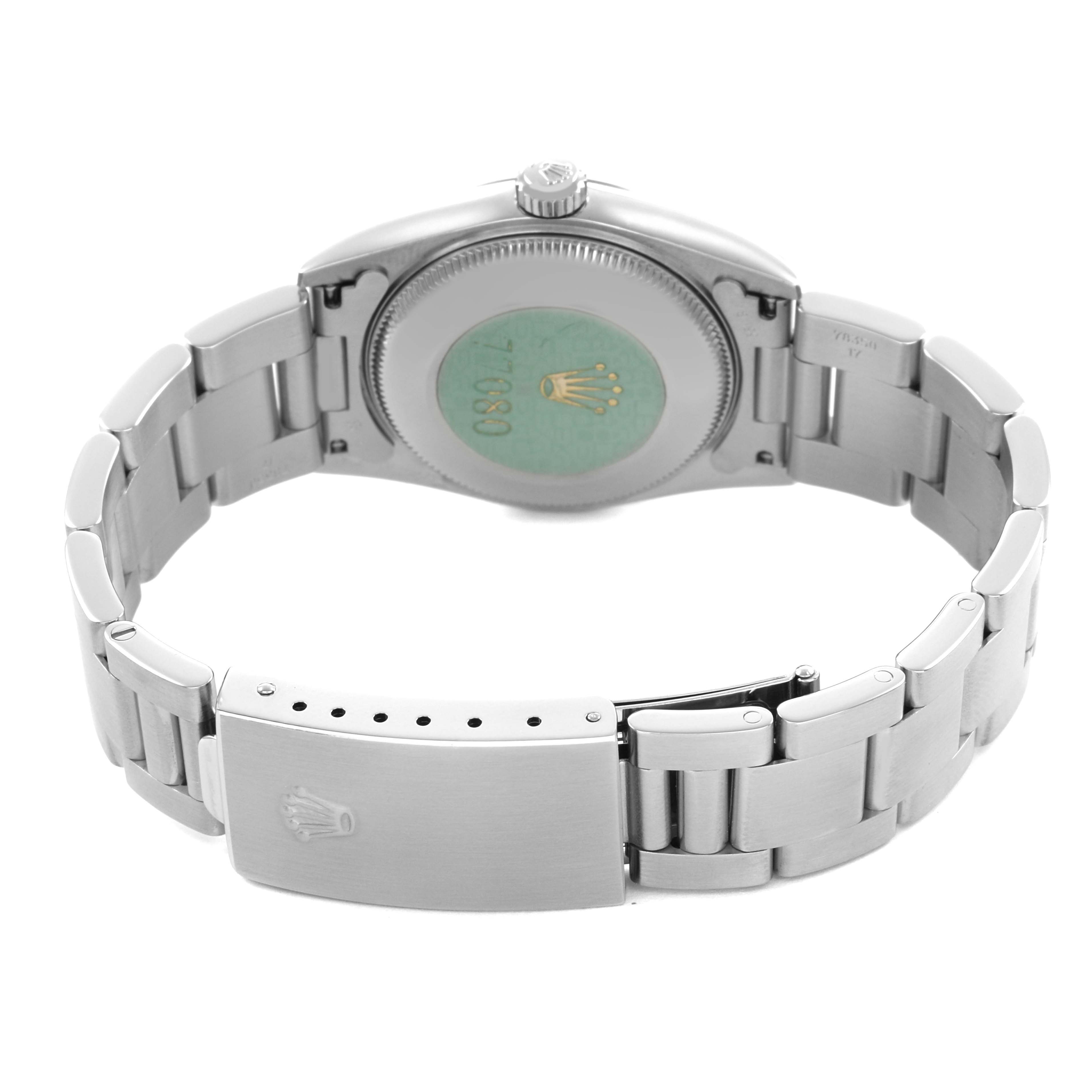 The image shows the back view of a Rolex Oyster Perpetual 77080 Women's Stainless Steel Black Dial watch, highlighting the closed clasp and bracelet links.