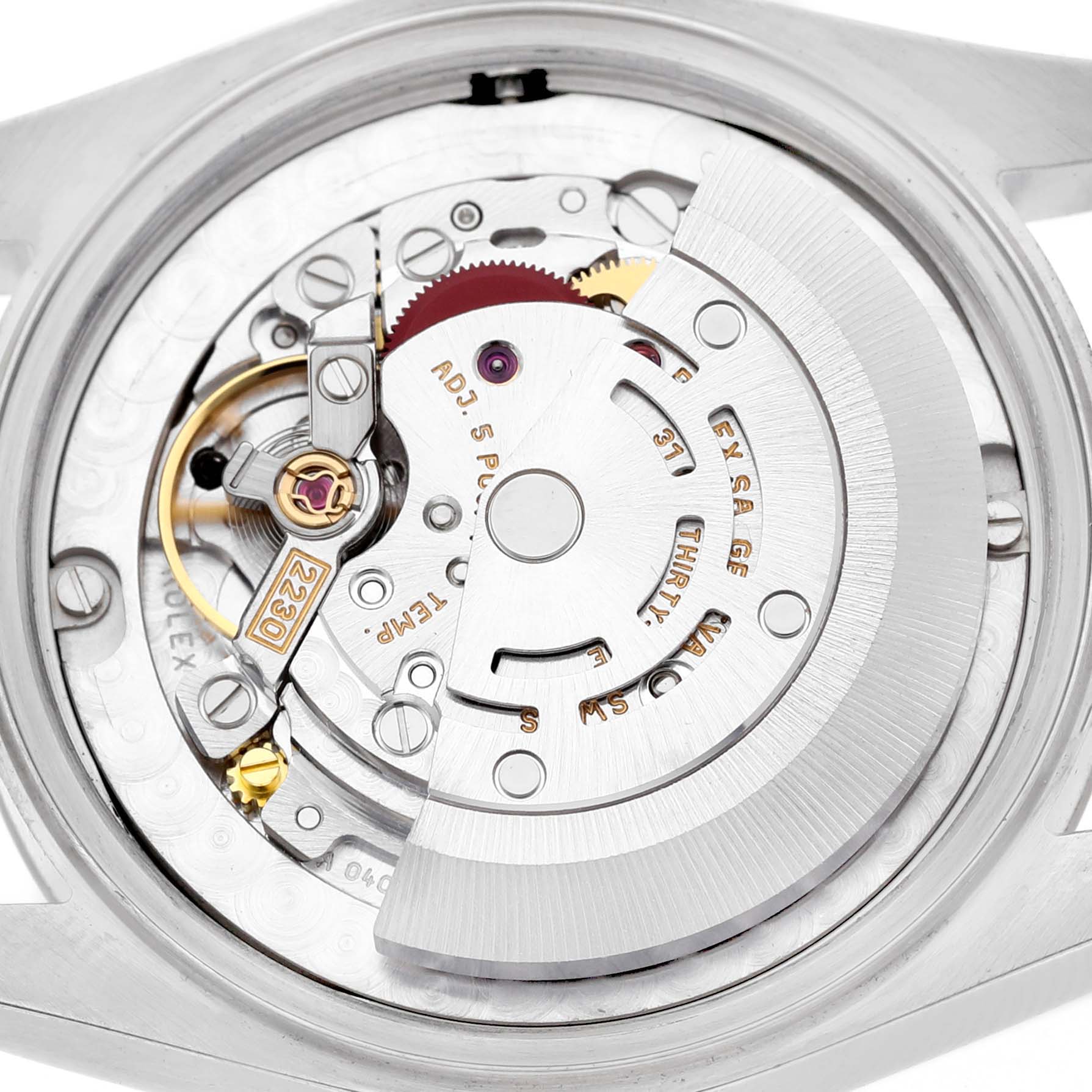 The image shows the movement of a Rolex Oyster Perpetual 77080 Women's Stainless Steel Black Dial watch with visible gears and rotor at a close-up angle.