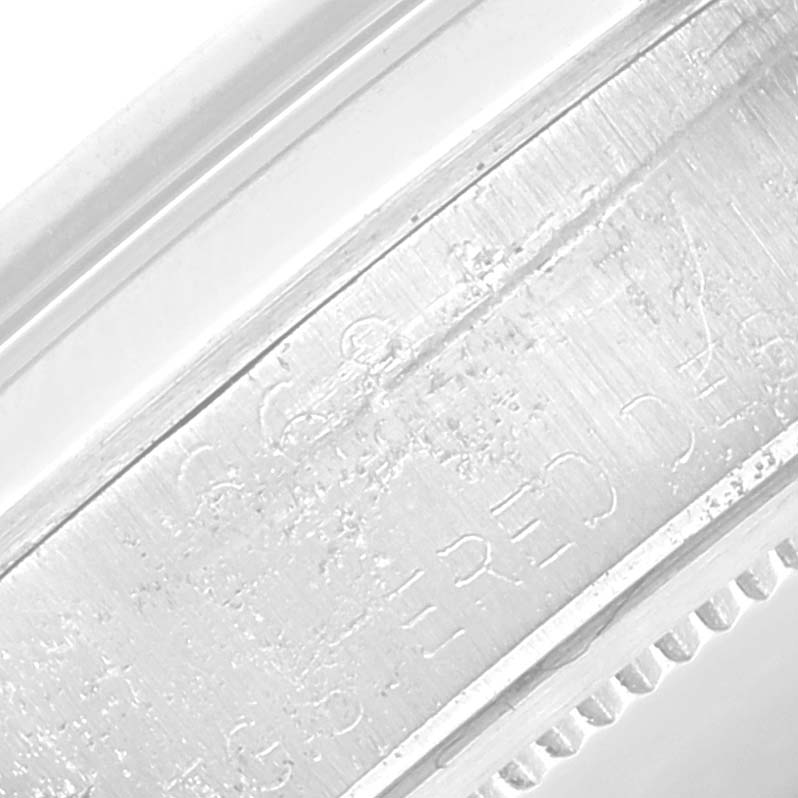 The image shows an extreme close-up of the side engraving details on a Rolex Vintage Collection 6694 Men's Stainless Steel Silver Dial 6694 Men's Stainless Steel Silver Dial watch.