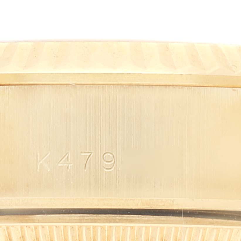 The image shows a close-up of the edge of the bezel and case of a Rolex President 79178 Women
s Yellow Gold Champagne Dial 79178 Women
s Yellow Gold Champagne Dial model watch with visible engravings.