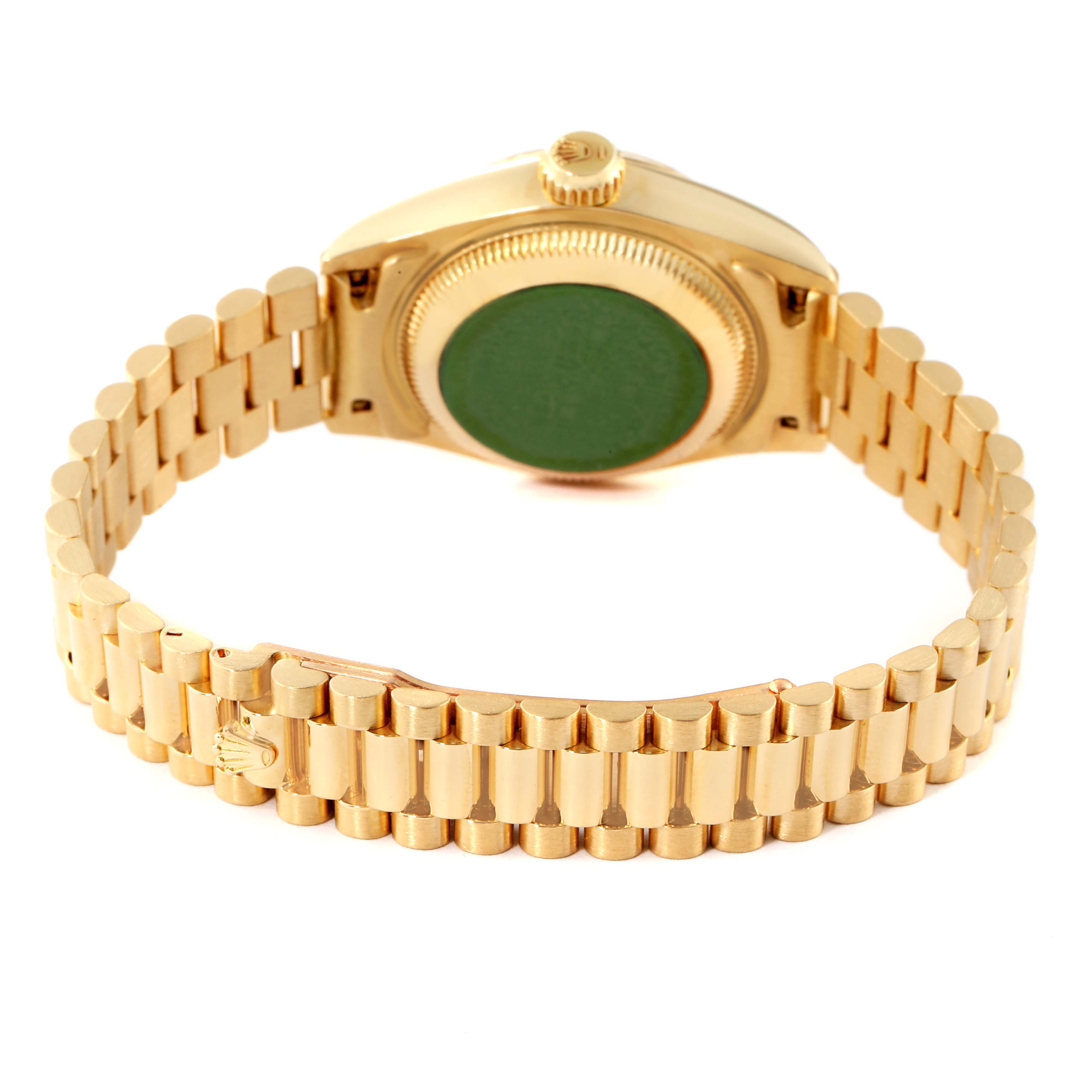 This image shows the back and bracelet of a Rolex President 69178 Women
s Yellow Gold Champagne Dial 69178 Women
s Yellow Gold Champagne Dial model watch with a green sticker on the case back.