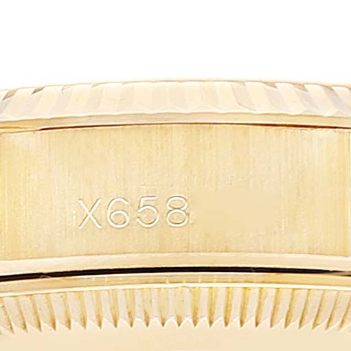 This image shows a close-up of the bezel and part of the band of a Rolex President 69178 Women
s Yellow Gold Champagne Dial 69178 Women
s Yellow Gold Champagne Dial model watch, featuring a serial number "X658."