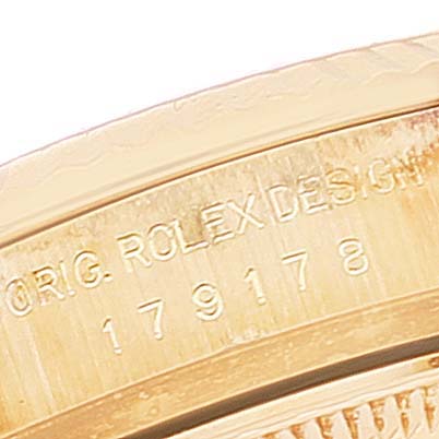 The image shows a close-up of the side of a Rolex President 179178 Women
s Yellow Gold Champagne Dial 179178 Women
s Yellow Gold Champagne Dial model watch case, displaying the engraved serial and model numbers.