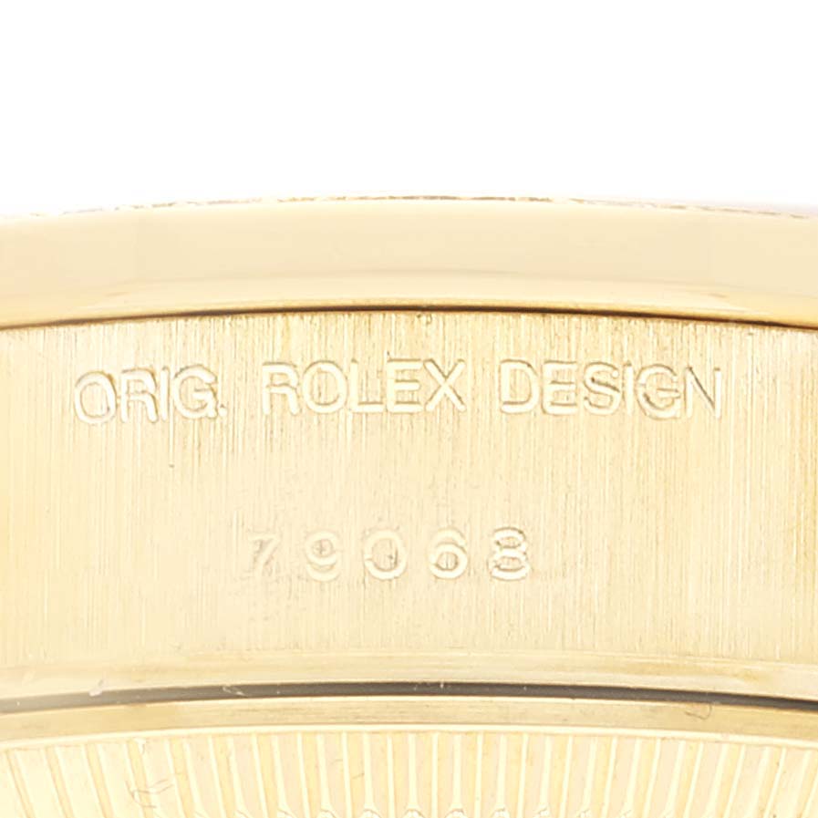 This image shows the side view of the Rolex President 79068 Women
s Yellow Gold Champagne Dial 79068 Women
s Yellow Gold Champagne Dial model with the engraving "ORIG. ROLEX DESIGN 79068".