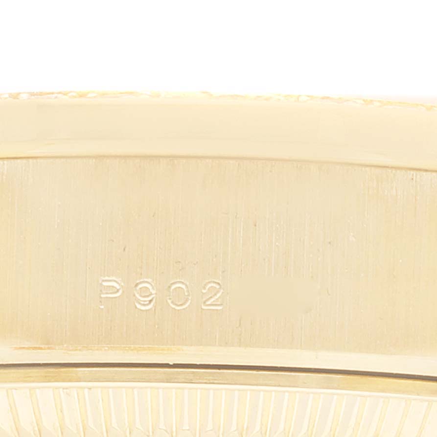 This image shows a close-up of the side of a Rolex President 79068 Women
s Yellow Gold Champagne Dial 79068 Women
s Yellow Gold Champagne Dial model watch, featuring the engraved serial number.