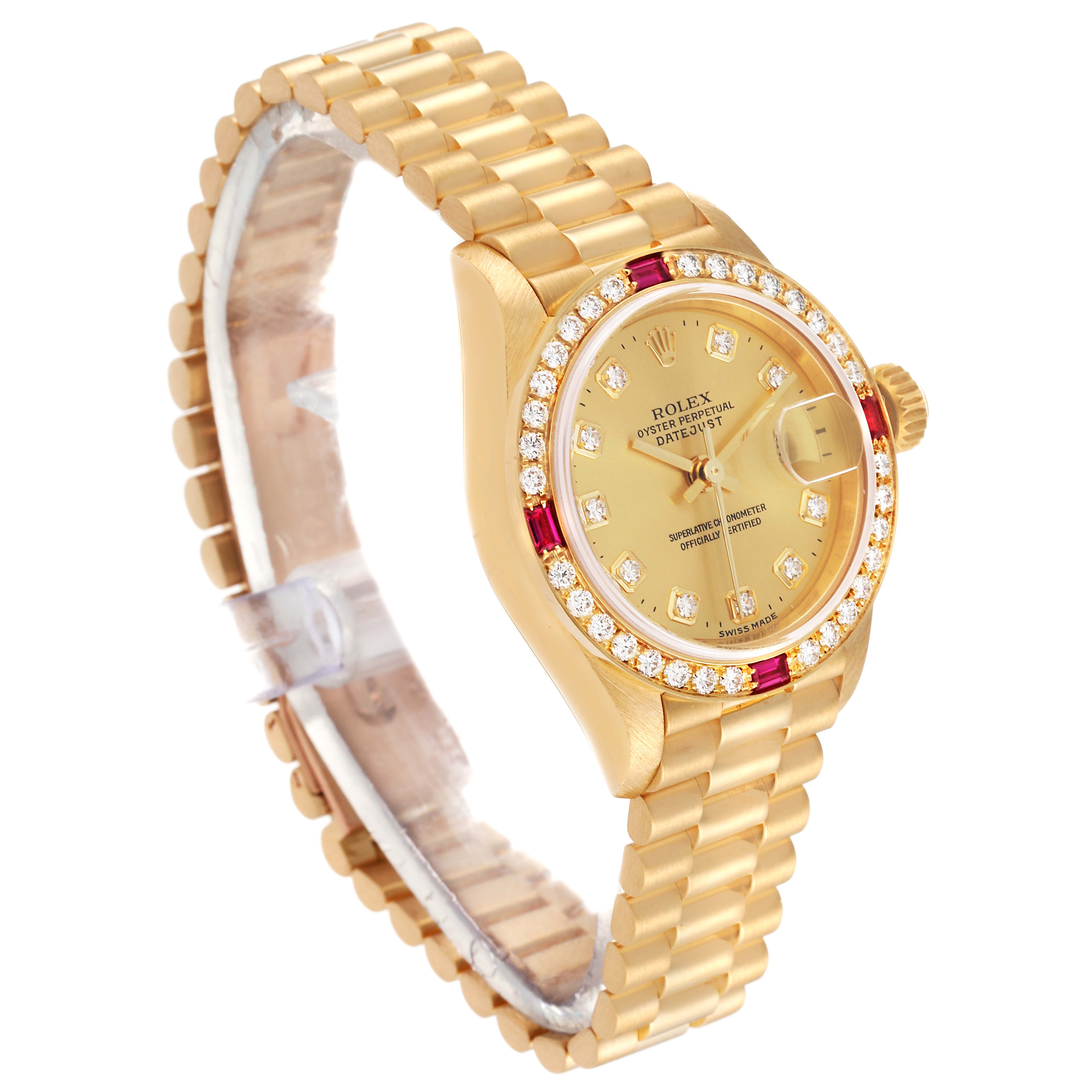 The Rolex President 79068 Women
s Yellow Gold Champagne Dial 79068 Women
s Yellow Gold Champagne Dial model watch is shown at a slight angle displaying its gold case, diamond and ruby bezel, dial, and bracelet.