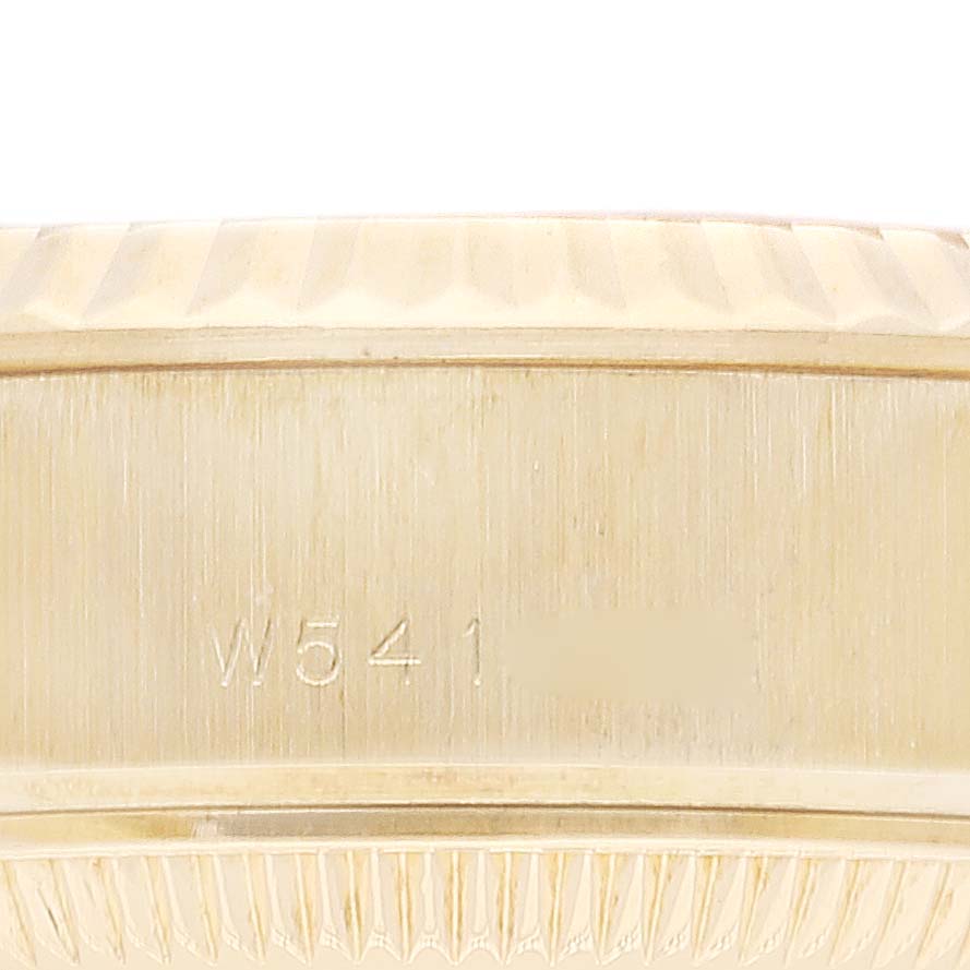 The image shows a close-up of the side of a Rolex President 69178 Women
s Yellow Gold Champagne Dial 69178 Women
s Yellow Gold Champagne Dial model watch case with engraved details.