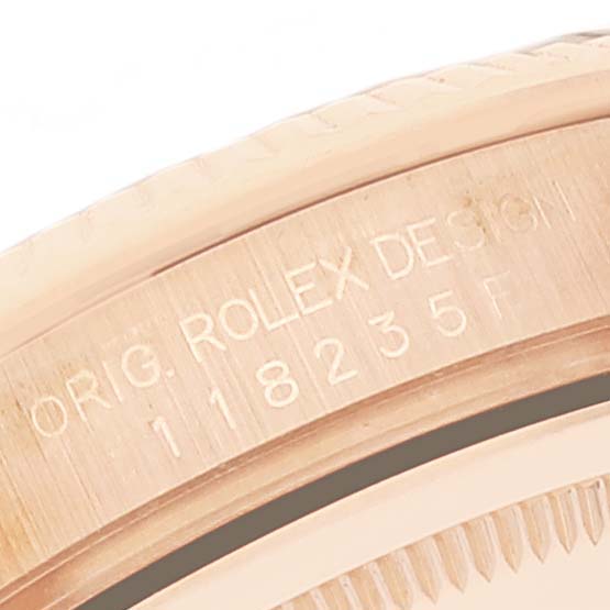 This close-up image shows the side and bezel engravings of a Rolex President 118235 Men's Rose Gold Brown Dial 118235 Men's Rose Gold Brown Dial model watch.