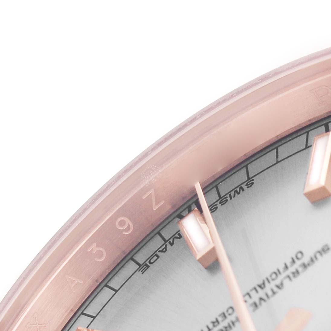 The image shows a close-up partial view of the Rolex President 118135 Men's Rose Gold Silver Dial watch face, highlighting the bezel and hour markers.