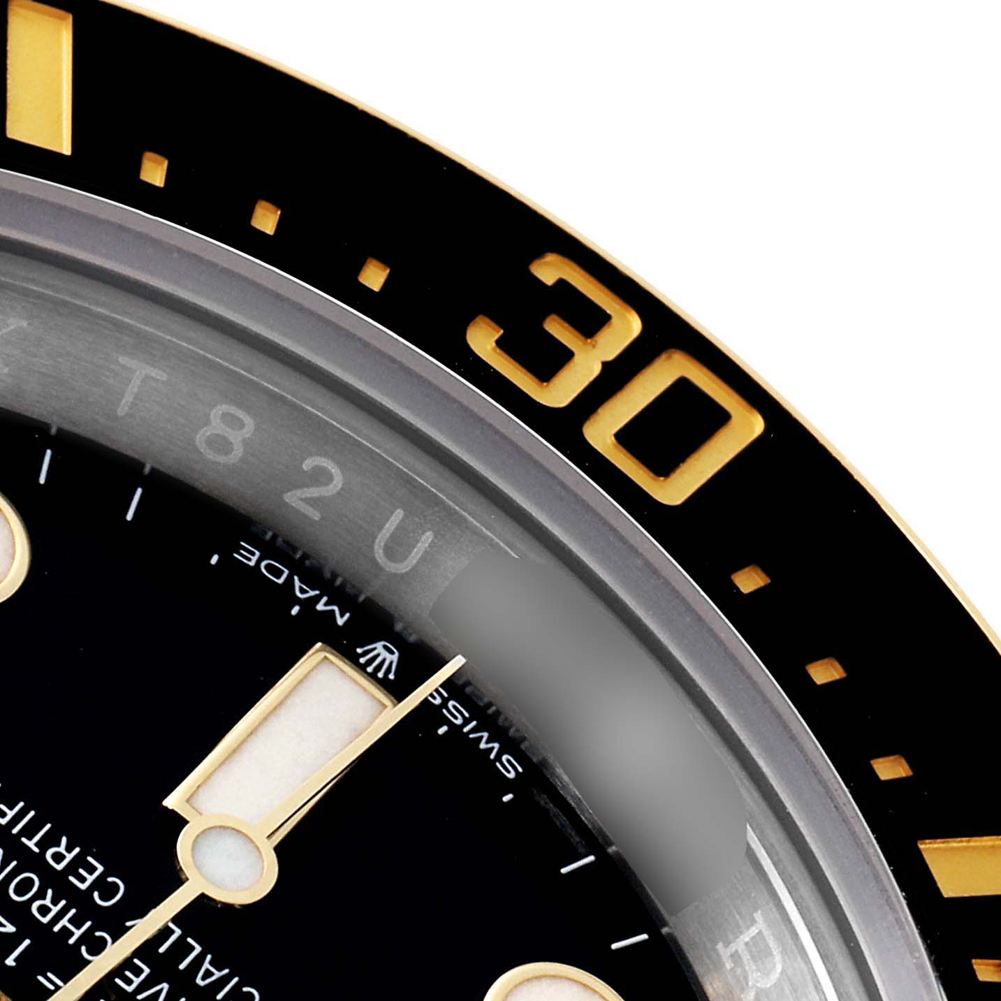 This is a close-up of the Rolex Sea-Dweller 126603 Men
s Steel and Gold (two tone) Black Dial 126603 Men
s Steel and Gold (two tone) Black Dial watch showing part of the dial and the "30" minute marker on the bezel.