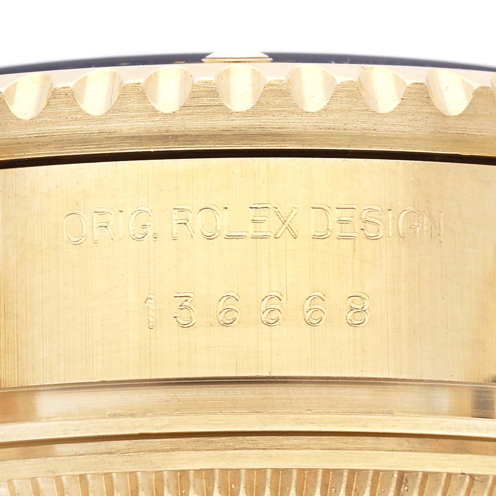 The image shows a close-up of the Rolex Sea-Dweller 136668LB Men
s Yellow Gold Blue Dial 136668LB Men
s Yellow Gold Blue Dial
s side, highlighting its engraved design and model number.