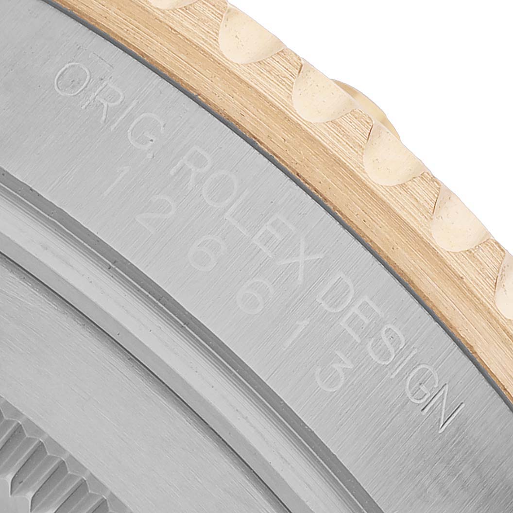 The image shows a close-up of the side casing of the Rolex Submariner 126613LN Men's Steel and Gold (two tone) Black Dial, highlighting the brushed metal finish and engravings.