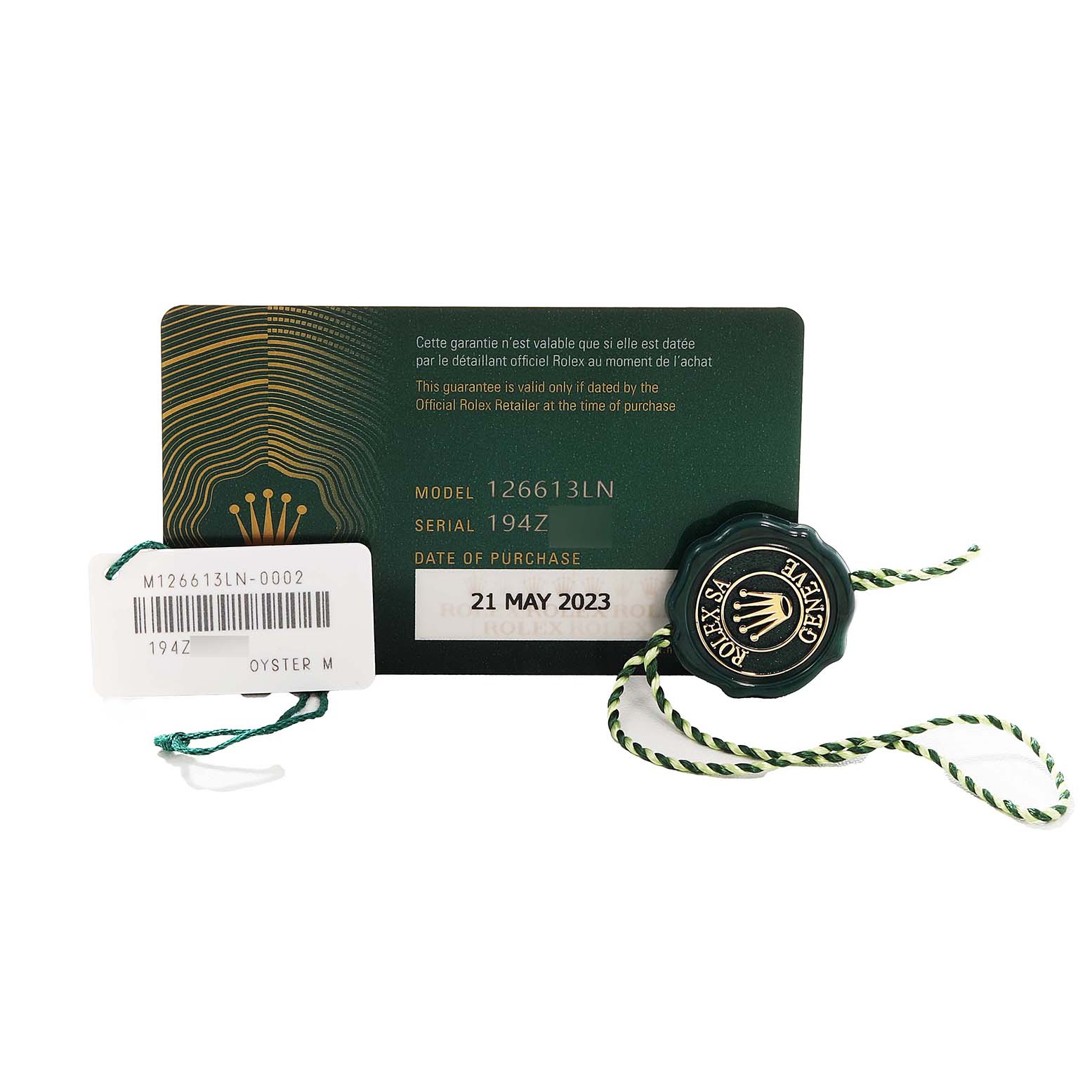 The image shows warranty and serial tags for a Rolex Submariner 126613LN Men's Steel and Gold (two tone) Black Dial, model 126613LN, and a green Rolex seal.