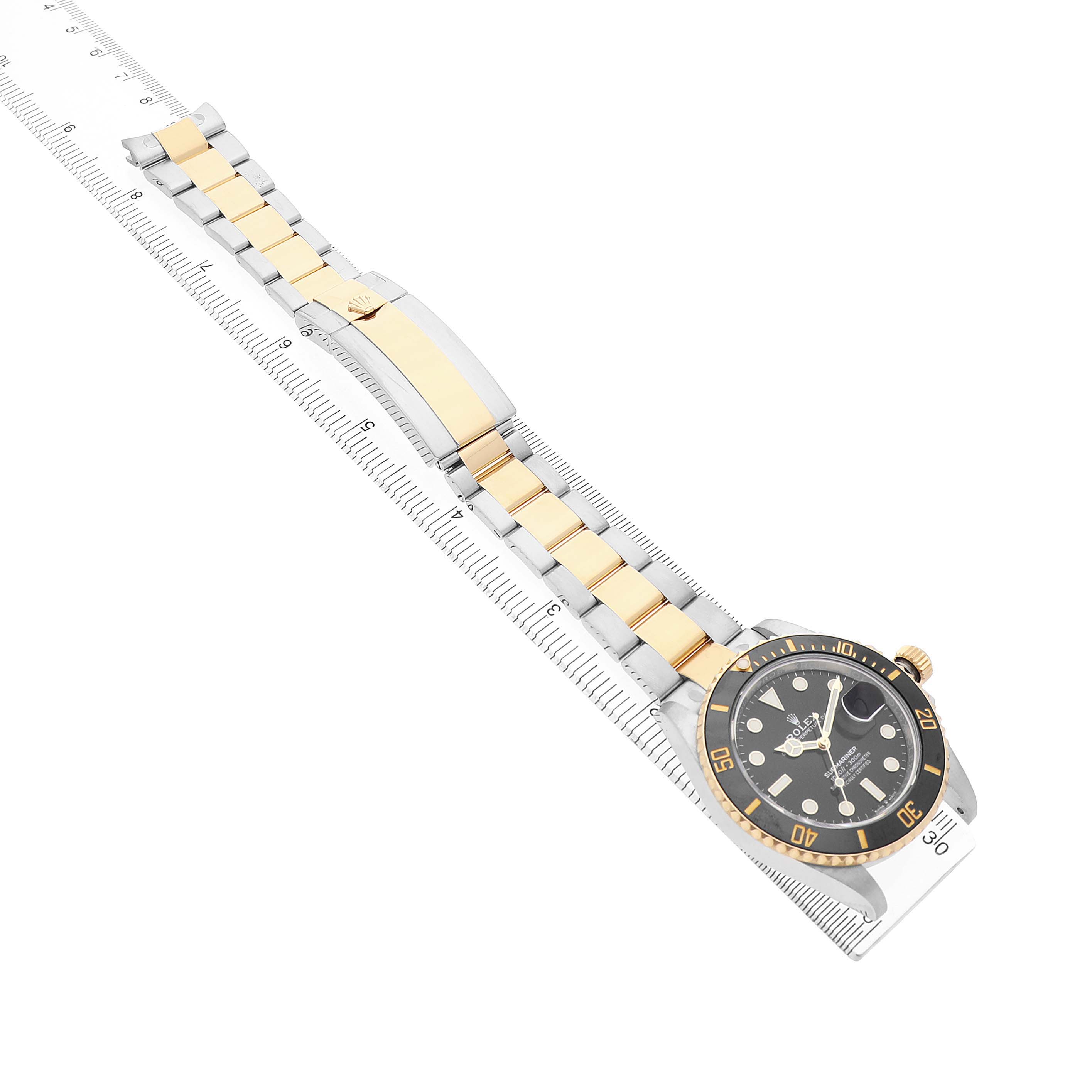 The Rolex Submariner 126613LN Men's Steel and Gold (two tone) Black Dial watch is shown diagonally, highlighting the gold and silver bracelet, clasp, and dial with markings.