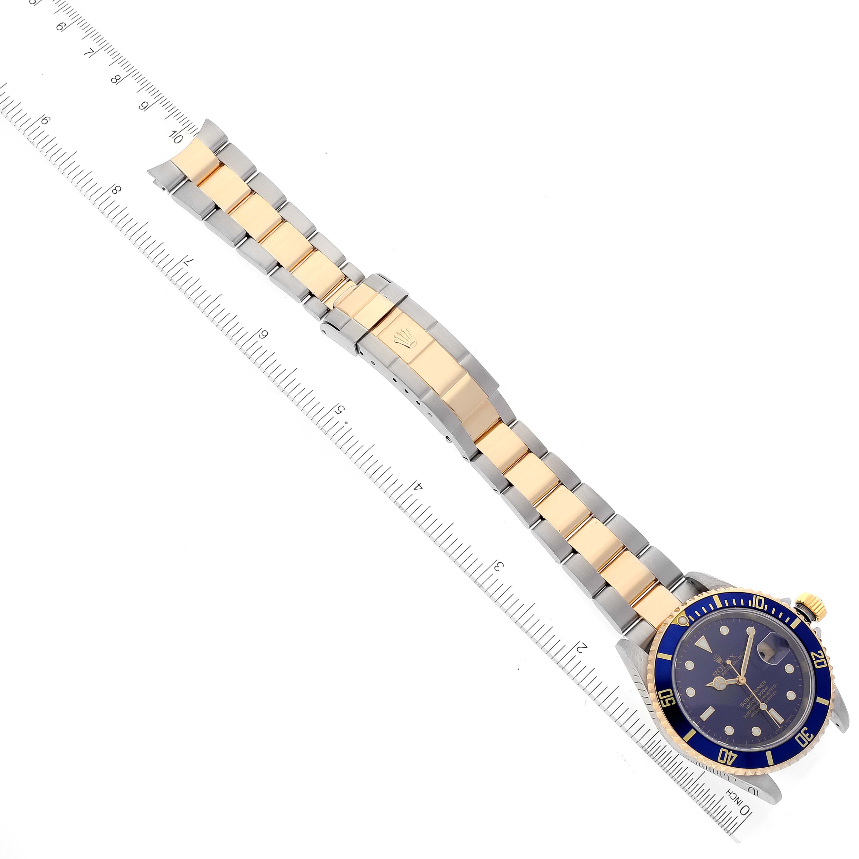 The image depicts a top-down view of a Rolex Submariner 16613 Men
s Steel and Gold (two tone) Blue Dial 16613 Men
s Steel and Gold (two tone) Blue Dial watch showing the full blue dial, bezel, and two-tone bracelet with clasp.