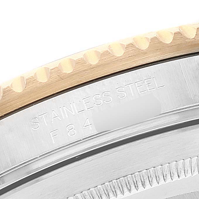 Close-up of the case back and edge of the bezel of a Rolex Submariner 16613 Men
s Steel and Gold (two tone) Blue Dial 16613 Men
s Steel and Gold (two tone) Blue Dial watch, showing "STAINLESS STEEL" engraving.