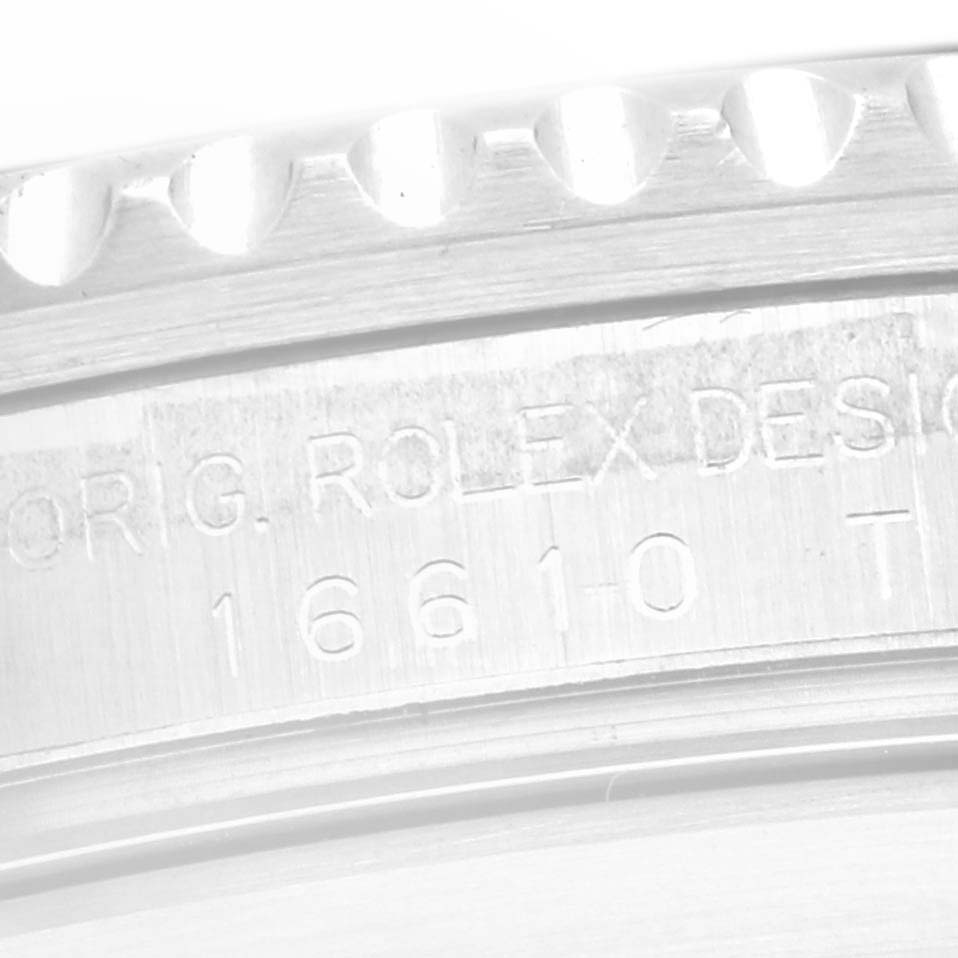 The image shows a close-up of the engraved case side of the Rolex Submariner 16610 Men
s Stainless Steel Black Dial 16610 Men
s Stainless Steel Black Dial, highlighting its model number and design.