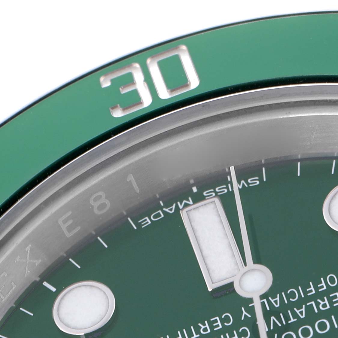 The image shows a close-up of the Rolex Submariner 116610LV Men
s Stainless Steel Green Dial 116610LV Men
s Stainless Steel Green Dial
s green bezel and part of the dial, including the 30-minute mark.