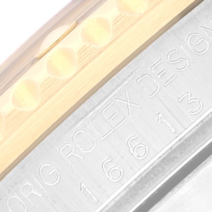 This close-up image shows the engraved serial number and part of the bezel of a Rolex Submariner 16613 Men's Steel and Gold (two tone) Champagne Dial 16613 Men's Steel and Gold (two tone) Champagne Dial watch.
