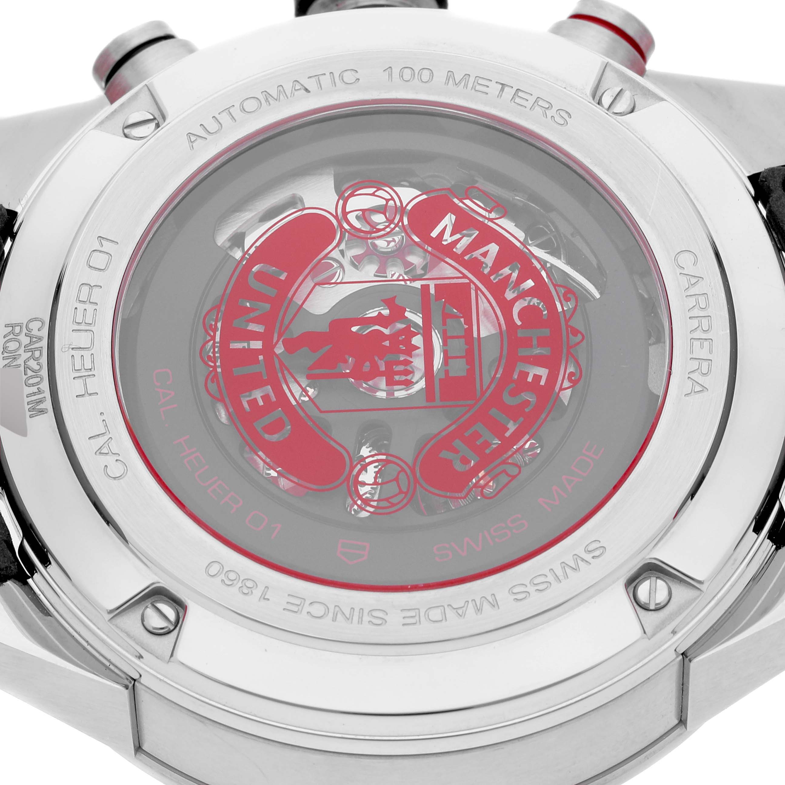 The image shows the back of the Tag Heuer Carrera Cal Heuer 01 Limited Edition watch, highlighting its transparent case and Manchester United logo.