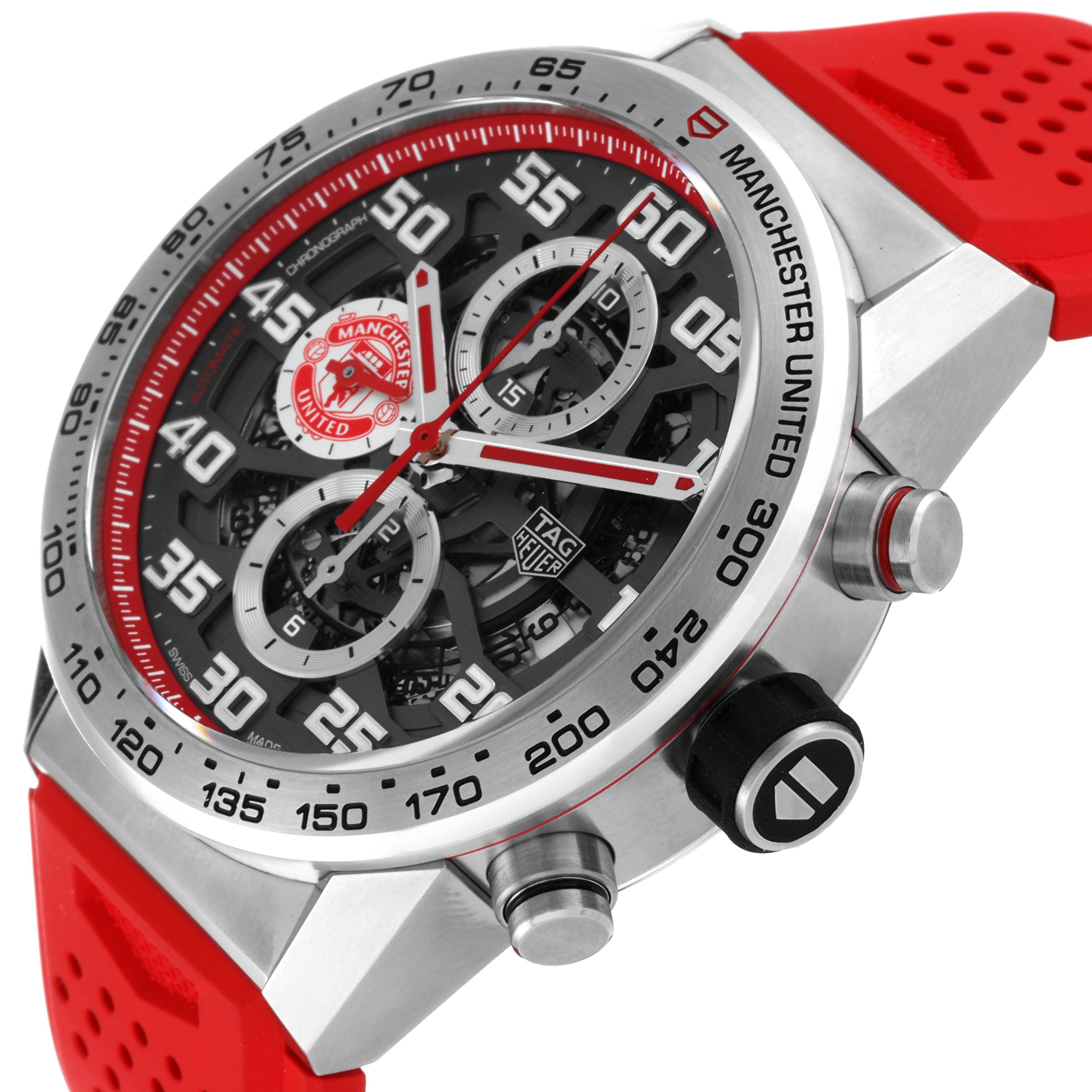 A diagonal close-up of the Tag Heuer Manchester United Limited Edition watch showcasing the face, bezel, and red strap.