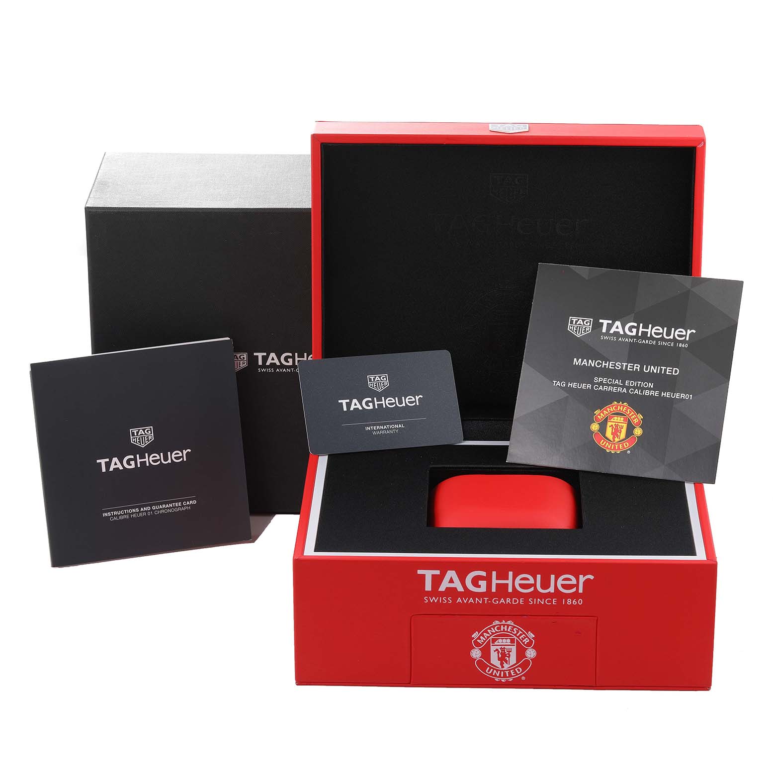 This image shows the packaging, instruction booklet, guarantee card, and presentation box of the Tag Heuer Carrera Calibre Heuer 01 Limited Edition watch.