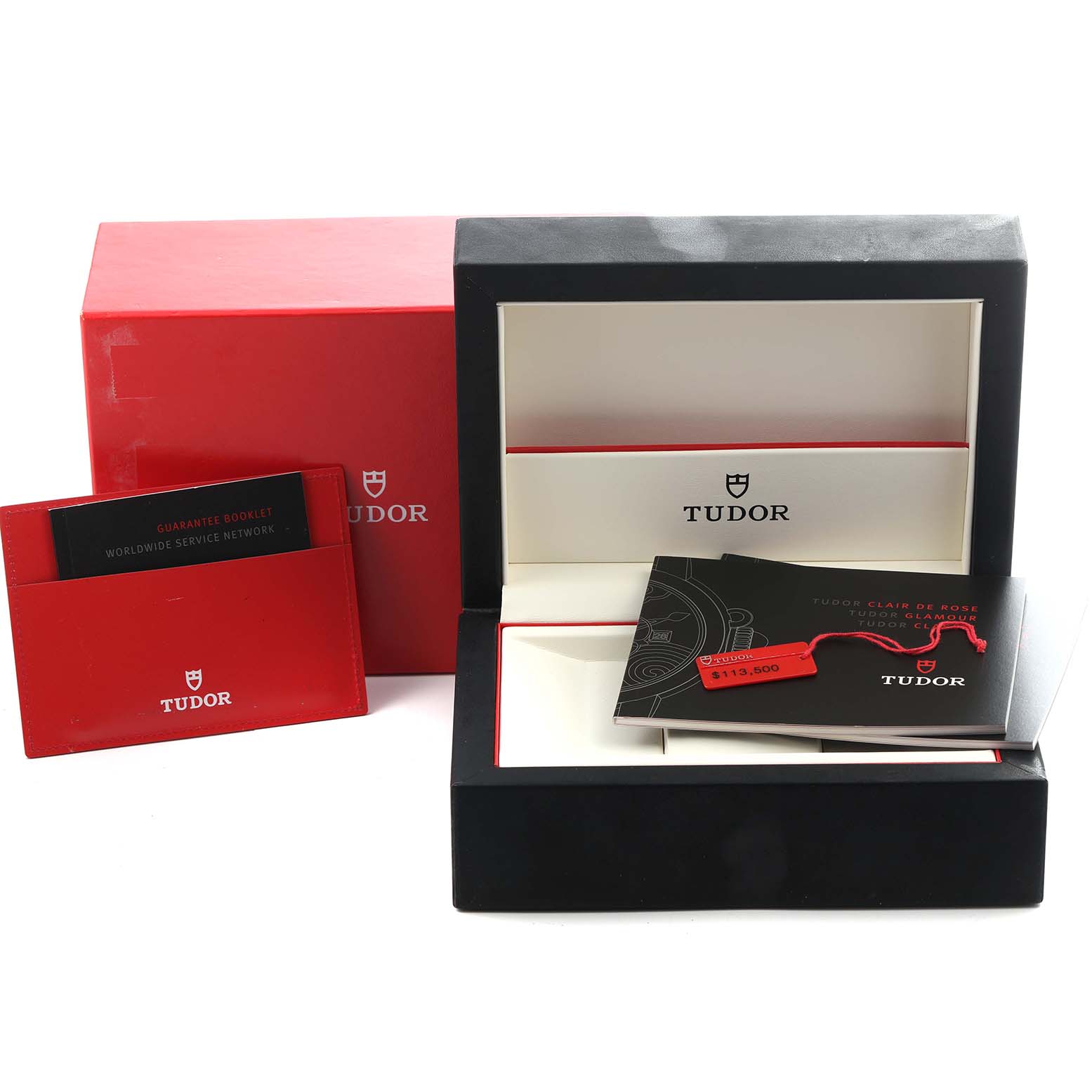 The image shows the Tudor Tiger 79280 Men
s Stainless Steel Blue Dial 79280 Men
s Stainless Steel Blue Dial model
s packaging, including a red and black box, booklet, and warranty card holder.