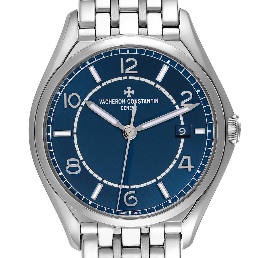 The Vacheron Constantin Fiftysix watch is shown from the front, displaying its blue dial, numerals, and stainless steel bracelet.
