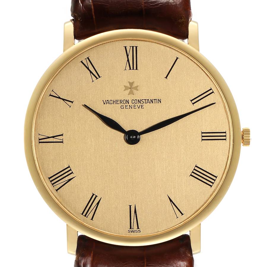 The Vacheron Constantin Patrimony watch is shown from a front angle, displaying its gold dial, Roman numerals, and brown leather strap.