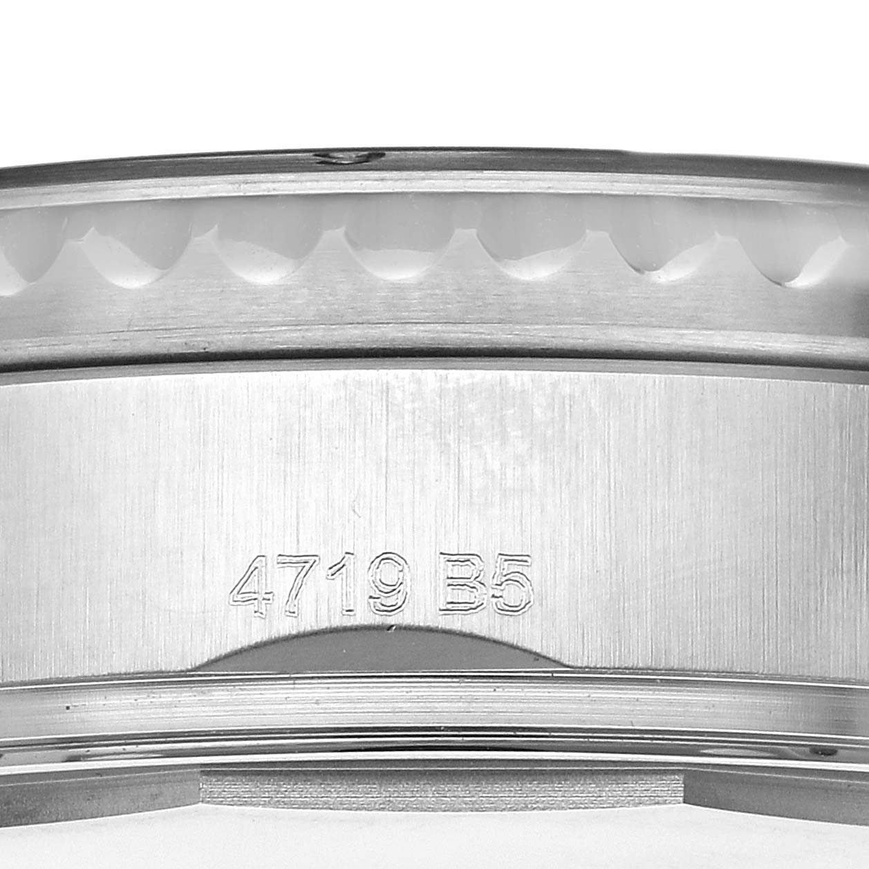 The image shows a close-up of the side of a Breitling Aviator A13316 Men's Stainless Steel Green Dial A13316 Men's Stainless Steel Green Dial watch case with a visible serial number engraved on it.