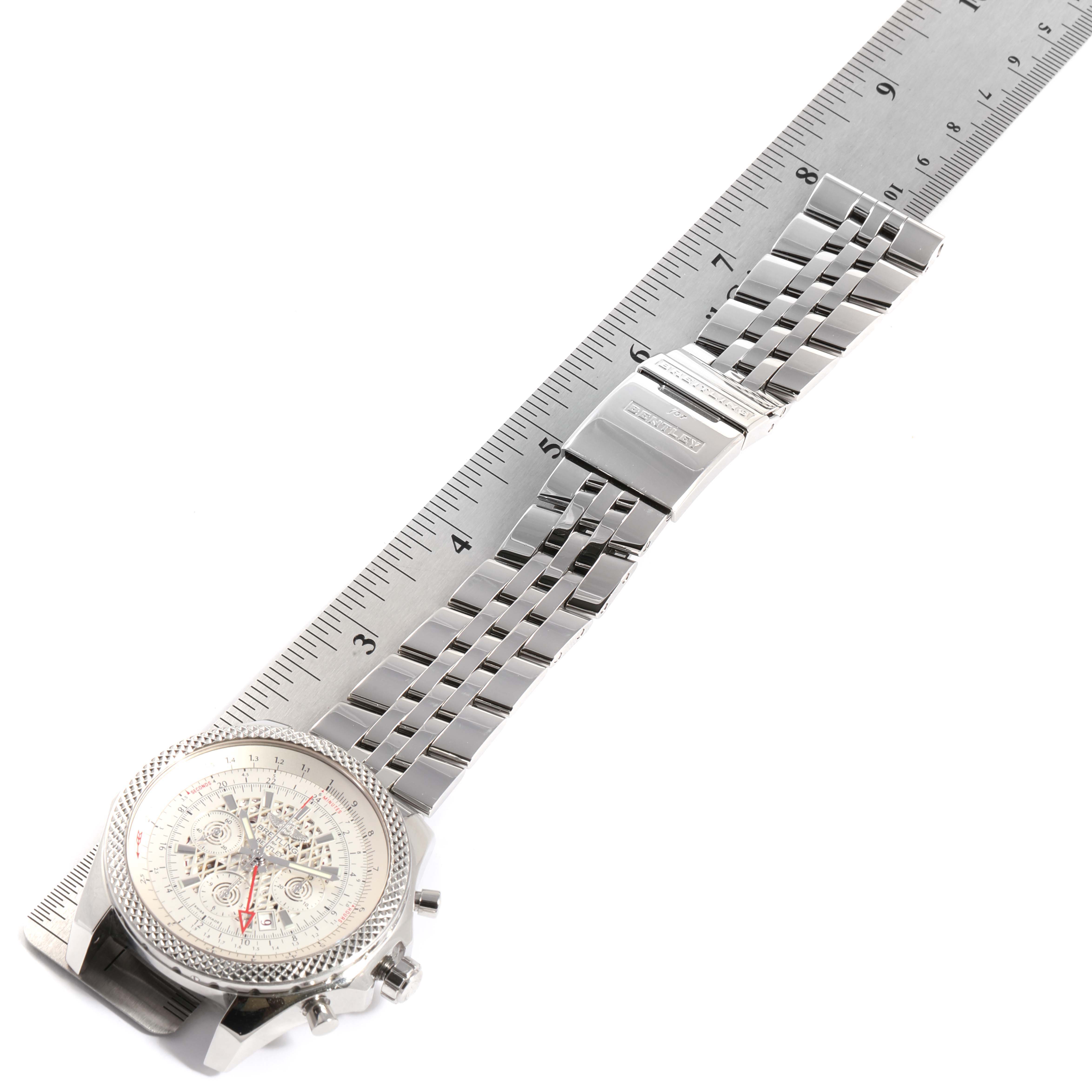 The image shows a Breitling Bentley AB0431  Men
s Stainless Steel Silver Dial AB0431  Men
s Stainless Steel Silver Dial watch laid flat with its face and metal bracelet extended alongside a ruler for scale.