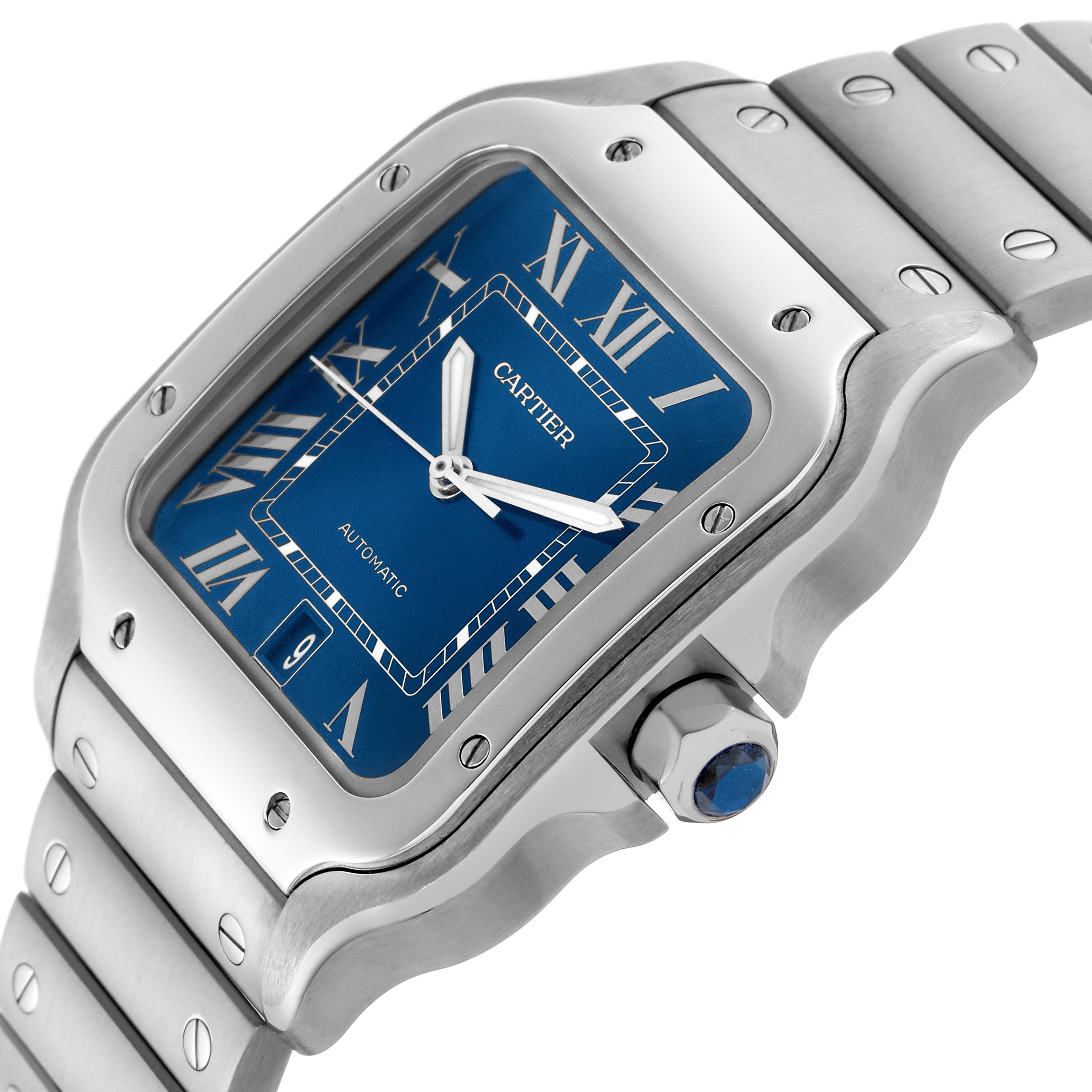 The Cartier Santos WSSA0030 Men
s Stainless Steel Blue Dial WSSA0030 Men
s Stainless Steel Blue Dial watch is shown at an angled view, highlighting the blue dial, stainless steel bezel, bracelet, and crown.