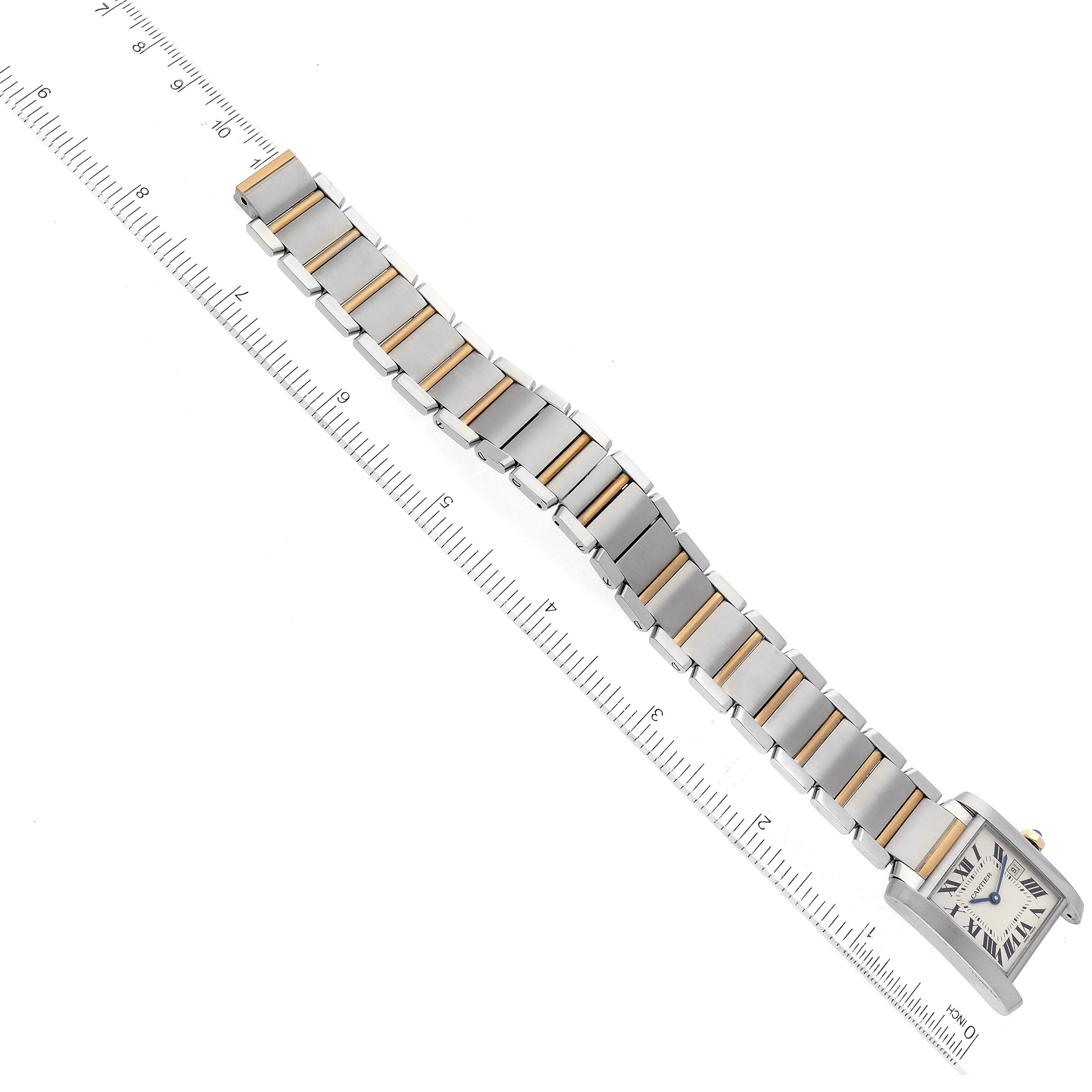 The image shows an overhead view of the Cartier Tank Francaise W51012Q4 Women's Steel and Gold (two tone) Silver Dial W51012Q4 Women's Steel and Gold (two tone) Silver Dial watch with its full bracelet extended alongside a ruler.