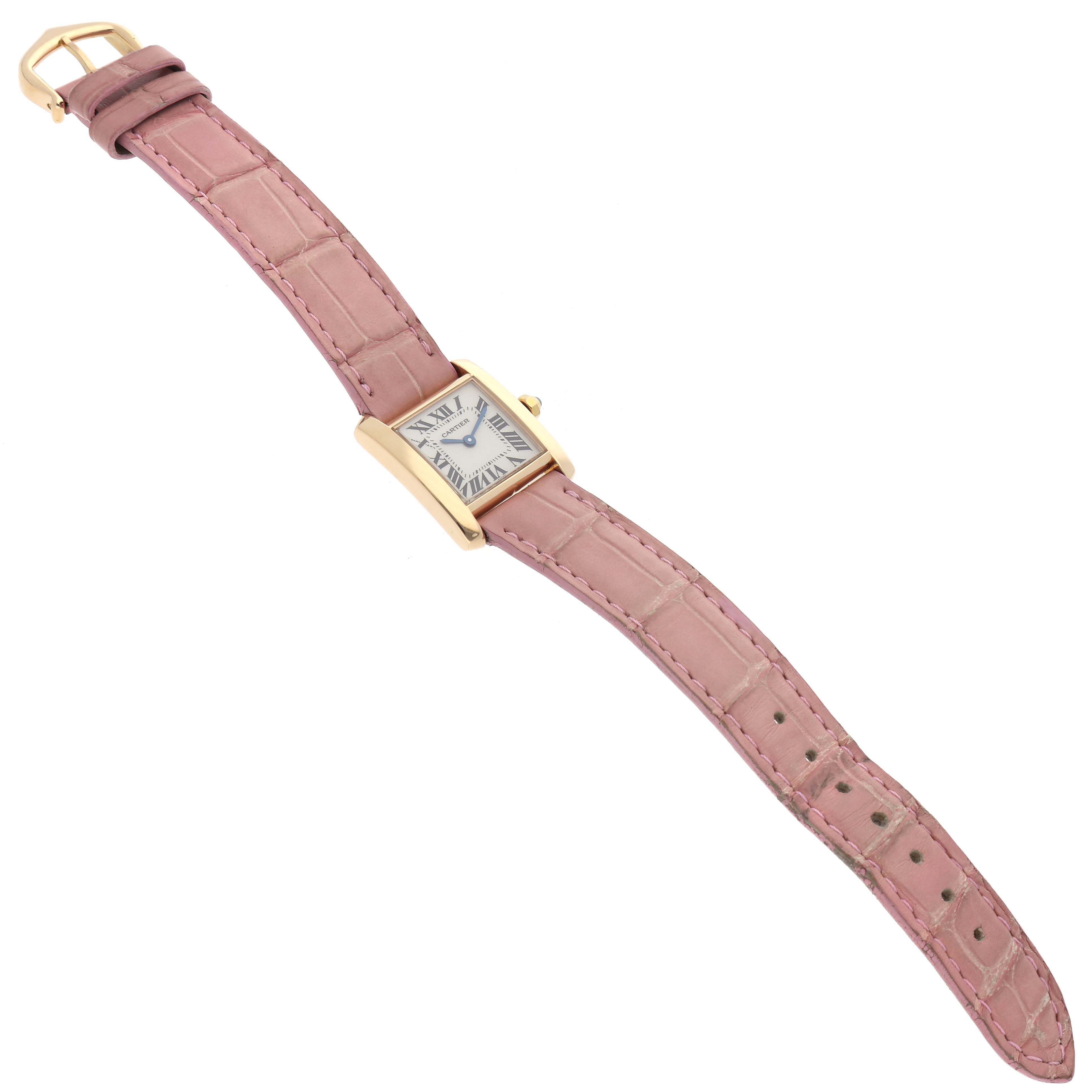 The image shows a Cartier Tank Francaise W5000256 Women
s Yellow Gold Silver Dial W5000256 Women
s Yellow Gold Silver Dial watch with a pink leather strap, displayed at a slight angle from above.