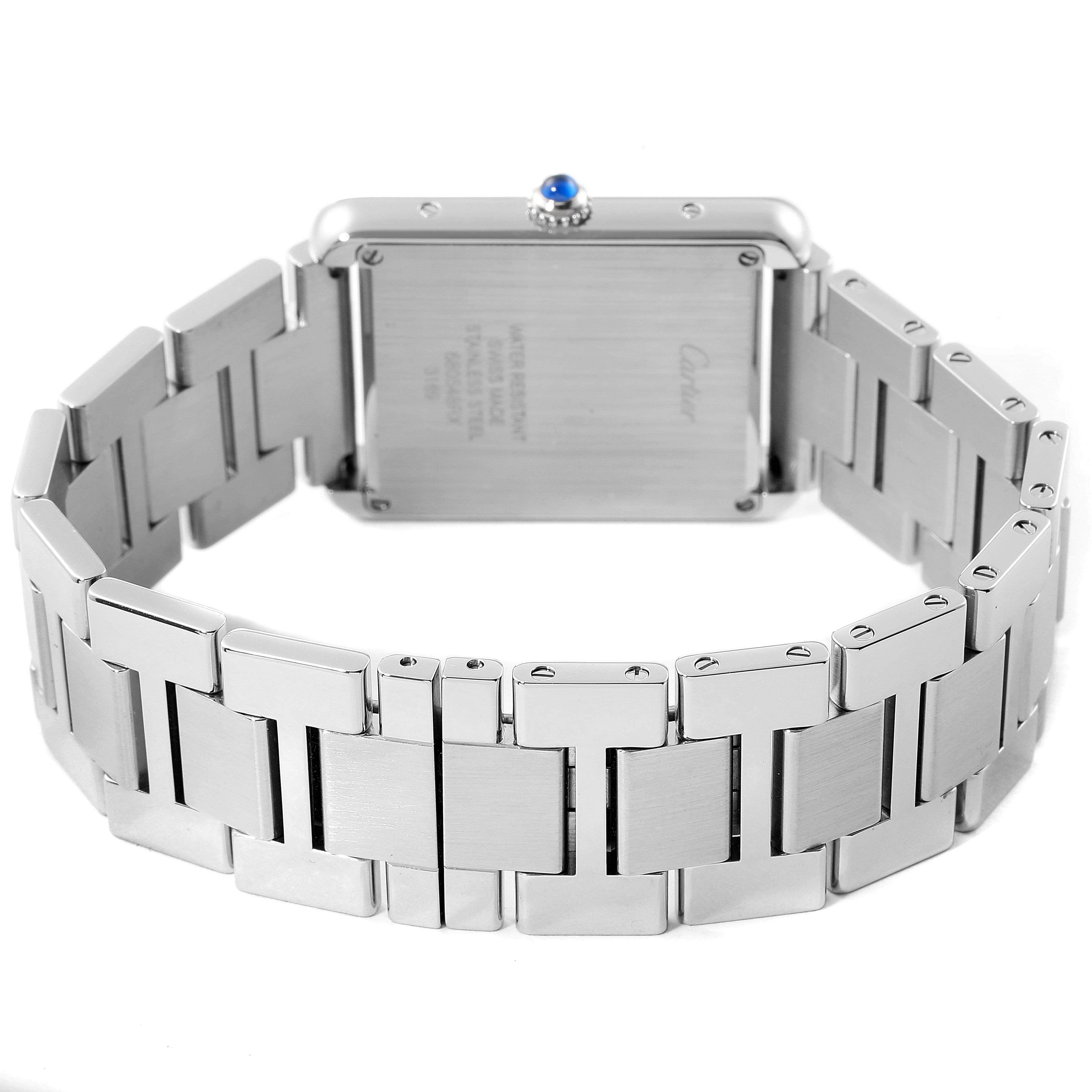 The image shows the back of a Tank Solo Cartier watch, focusing on the stainless steel bracelet and case back.