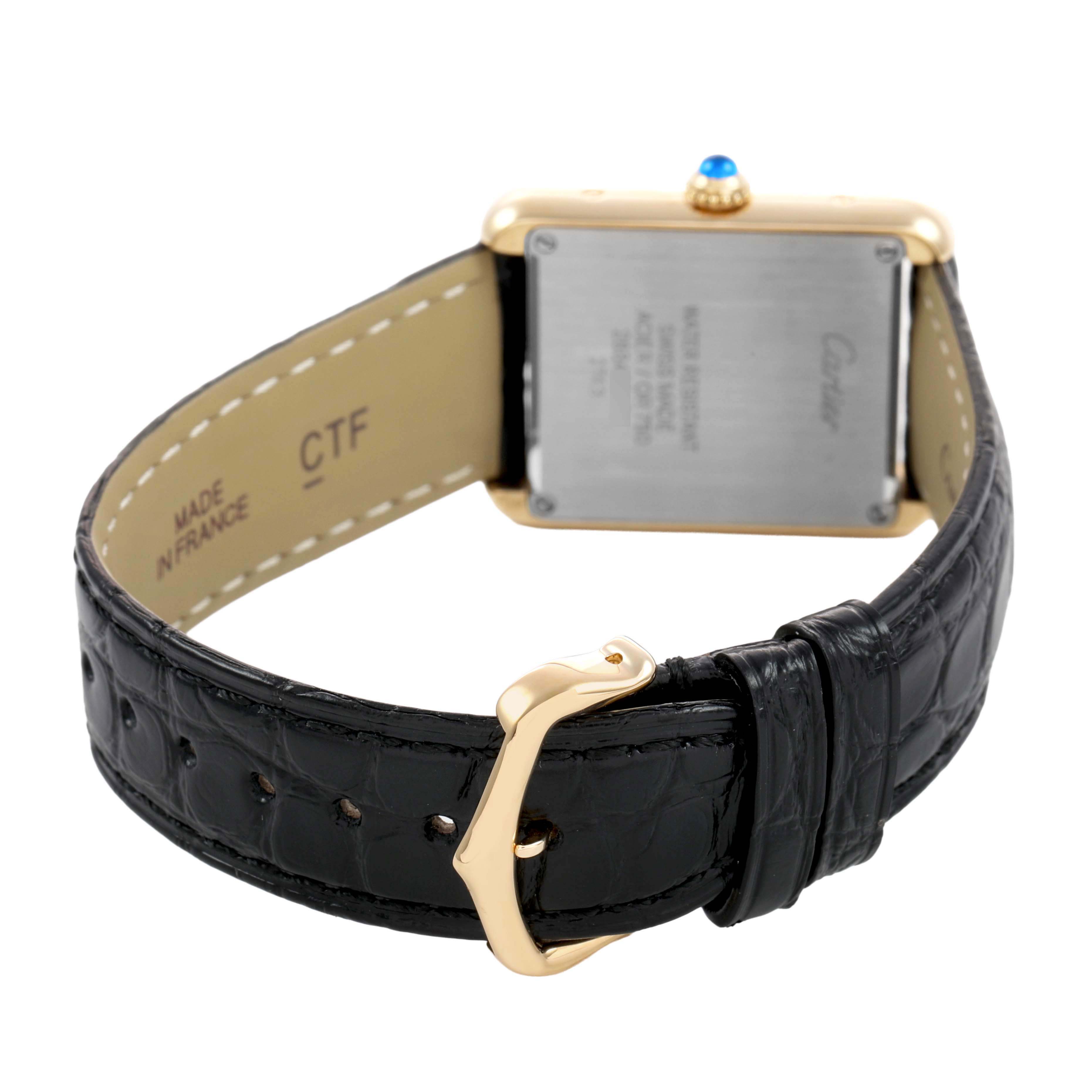 The image shows the back view of the Cartier Tank Solo W1018755 Women's Yellow Gold Silver Dial watch, highlighting the case back, strap, and buckle.
