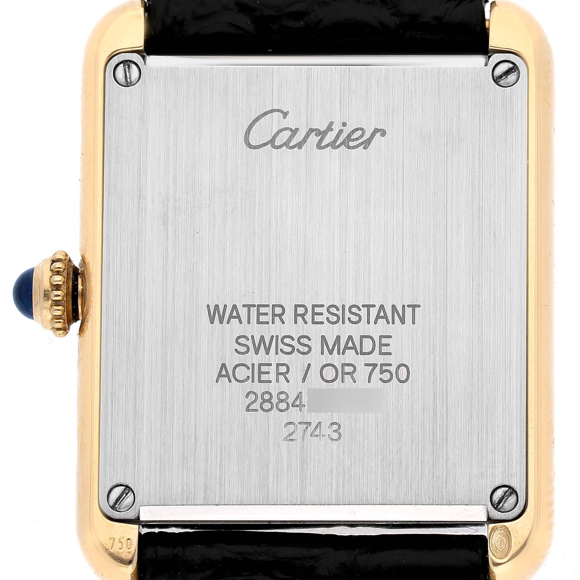 The image shows the back of a Cartier Tank Solo W1018755 Women's Yellow Gold Silver Dial watch, highlighting its metal case and markings.