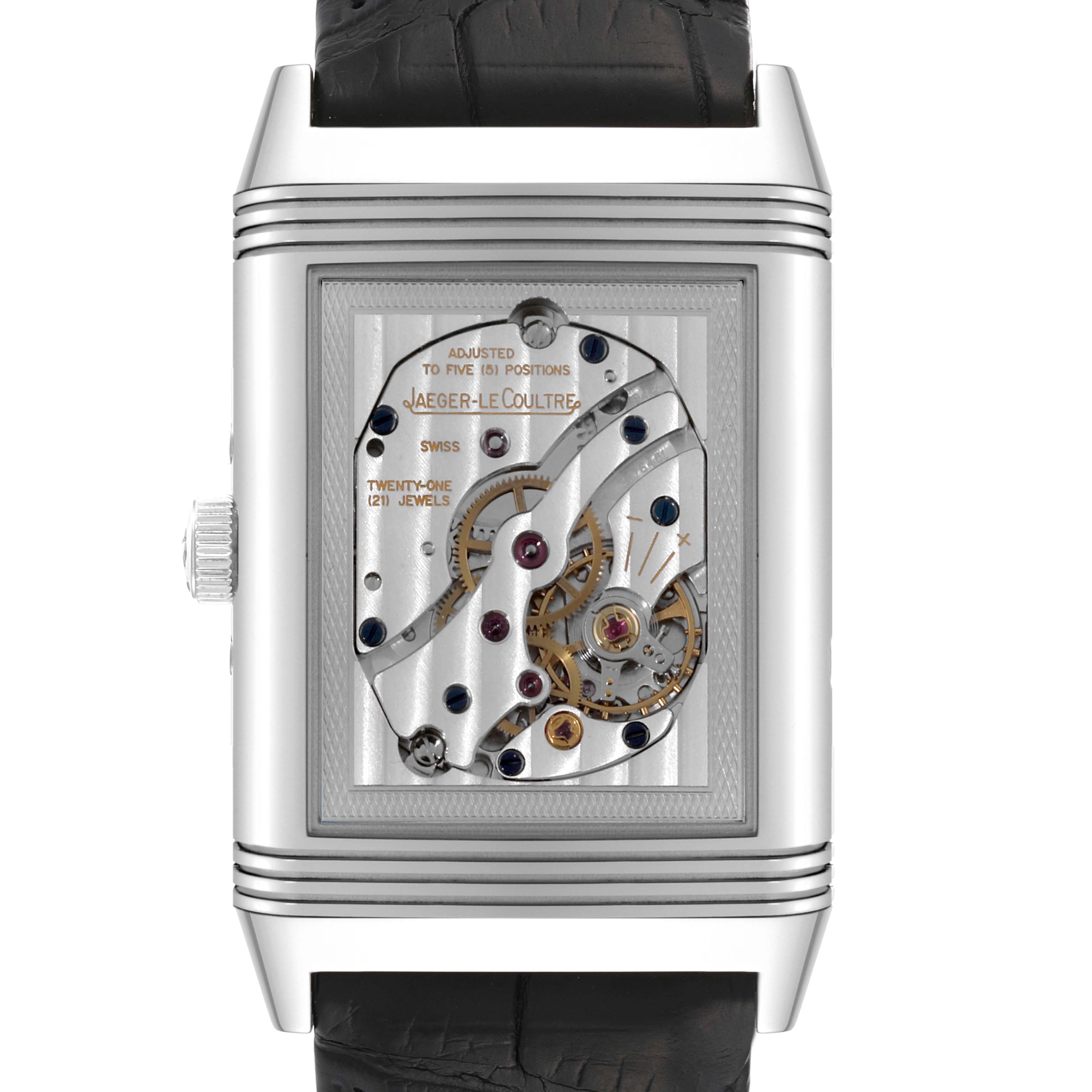 The image shows the back view of a Jaeger-LeCoultre Reverso watch, displaying its internal mechanical movement.