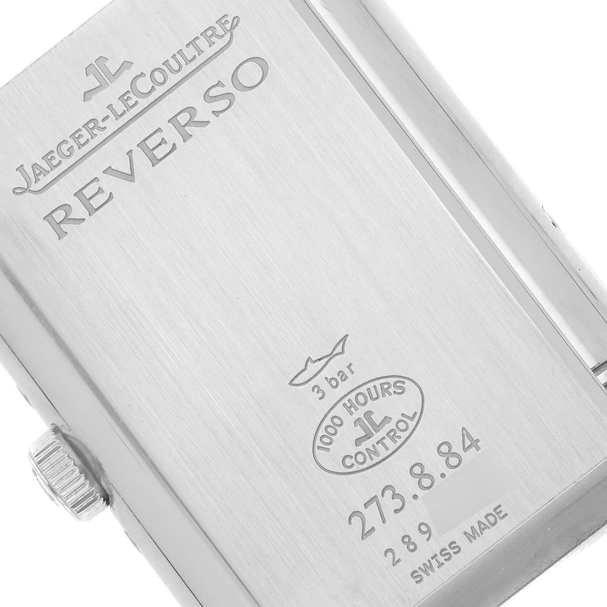 The image shows the back case of a Jaeger-LeCoultre Reverso watch, displaying the brand, model, and specifications.
