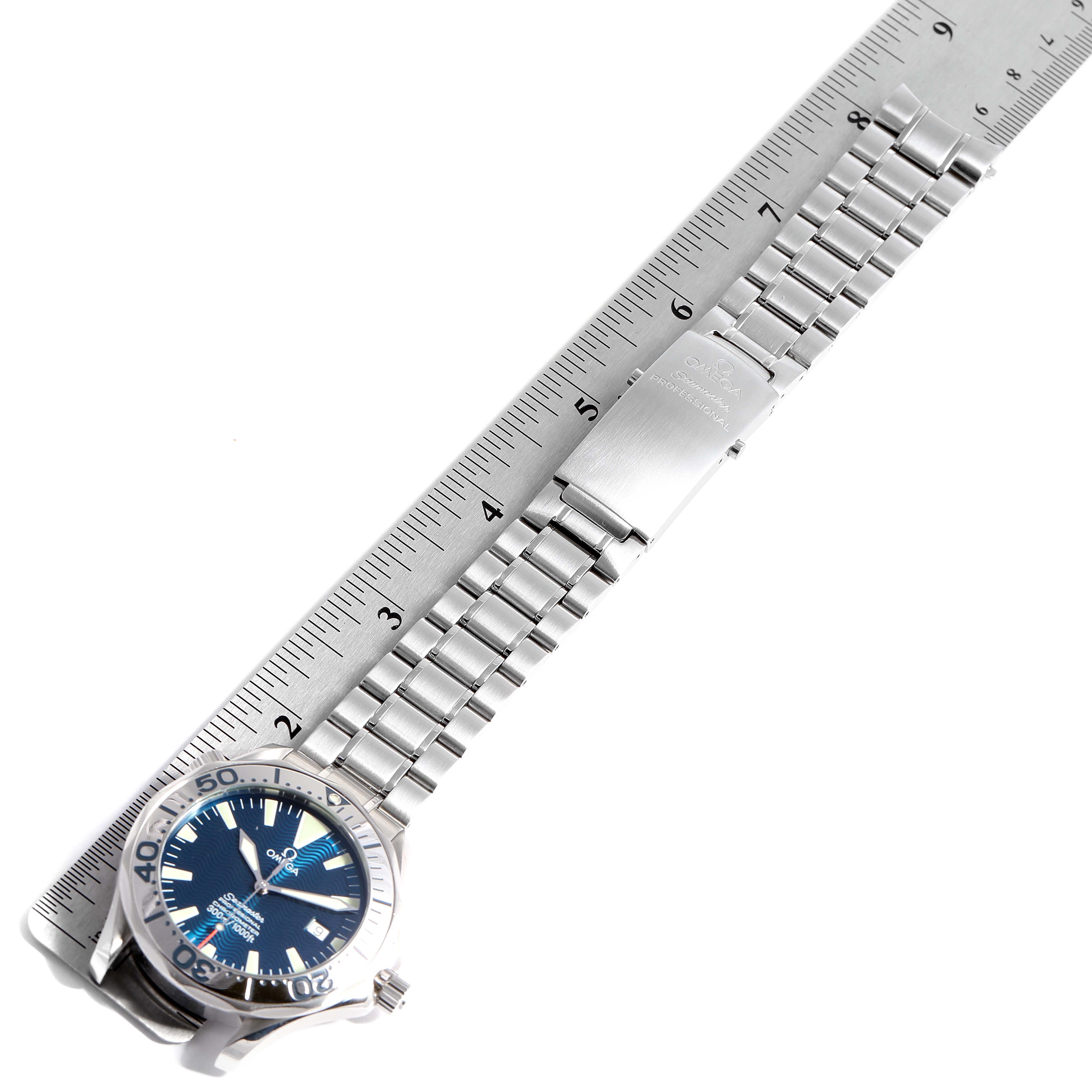 The image shows an Omega Seamaster 2255.80.00 Men
s Stainless Steel Blue Dial 2255.80.00 Men
s Stainless Steel Blue Dial watch laid flat with its metallic bracelet extended and positioned next to a ruler for measurement.