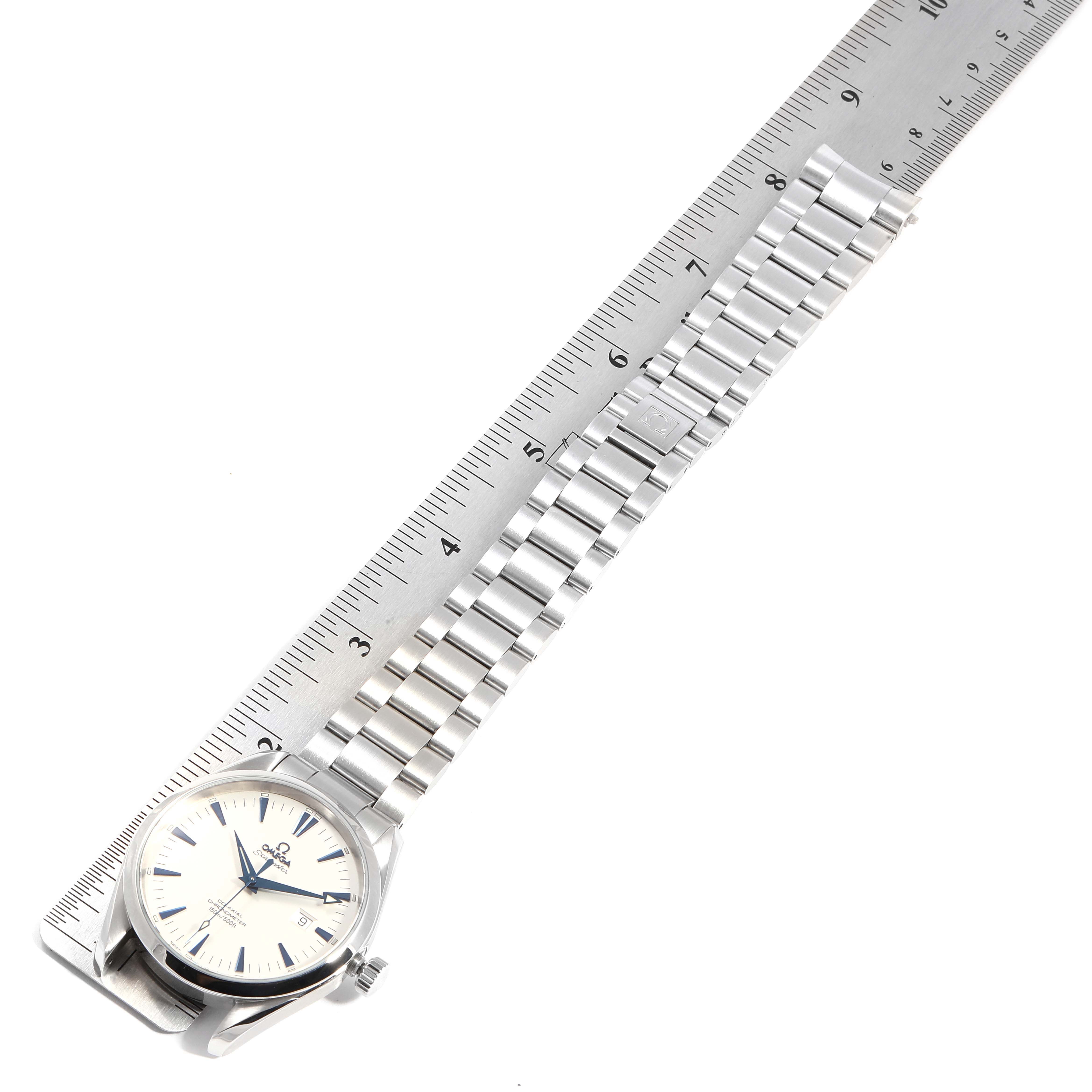 The Omega Seamaster 2502.33.00 Men's Stainless Steel White Dial 2502.33.00 Men's Stainless Steel White Dial watch is shown from a top-down angle, with its stainless steel bracelet aligned next to a ruler.