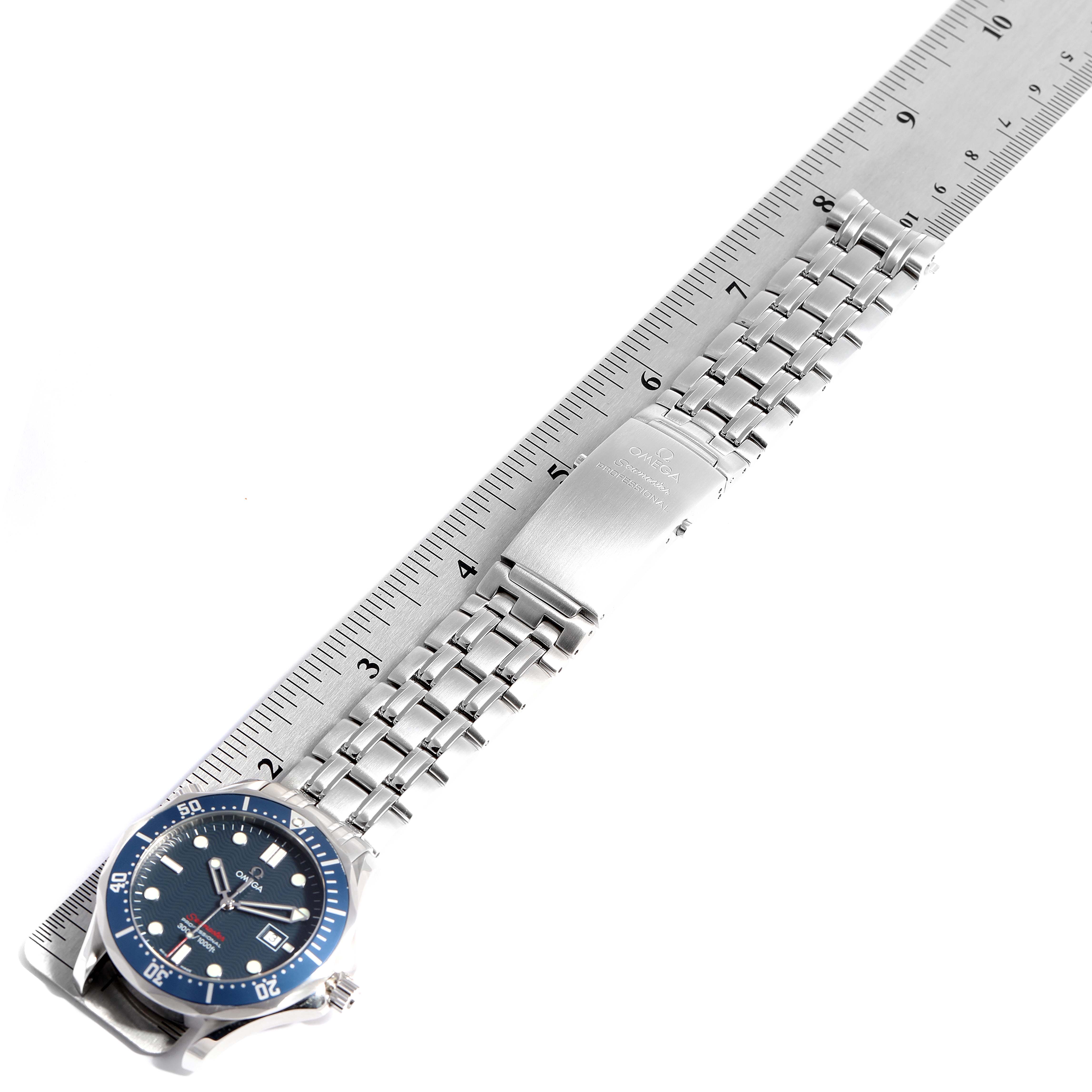 The image shows an Omega Seamaster 2221.80.00 Men
s Stainless Steel Blue Dial 2221.80.00 Men
s Stainless Steel Blue Dial watch laid flat next to a ruler, highlighting its dial, bezel, and bracelet.