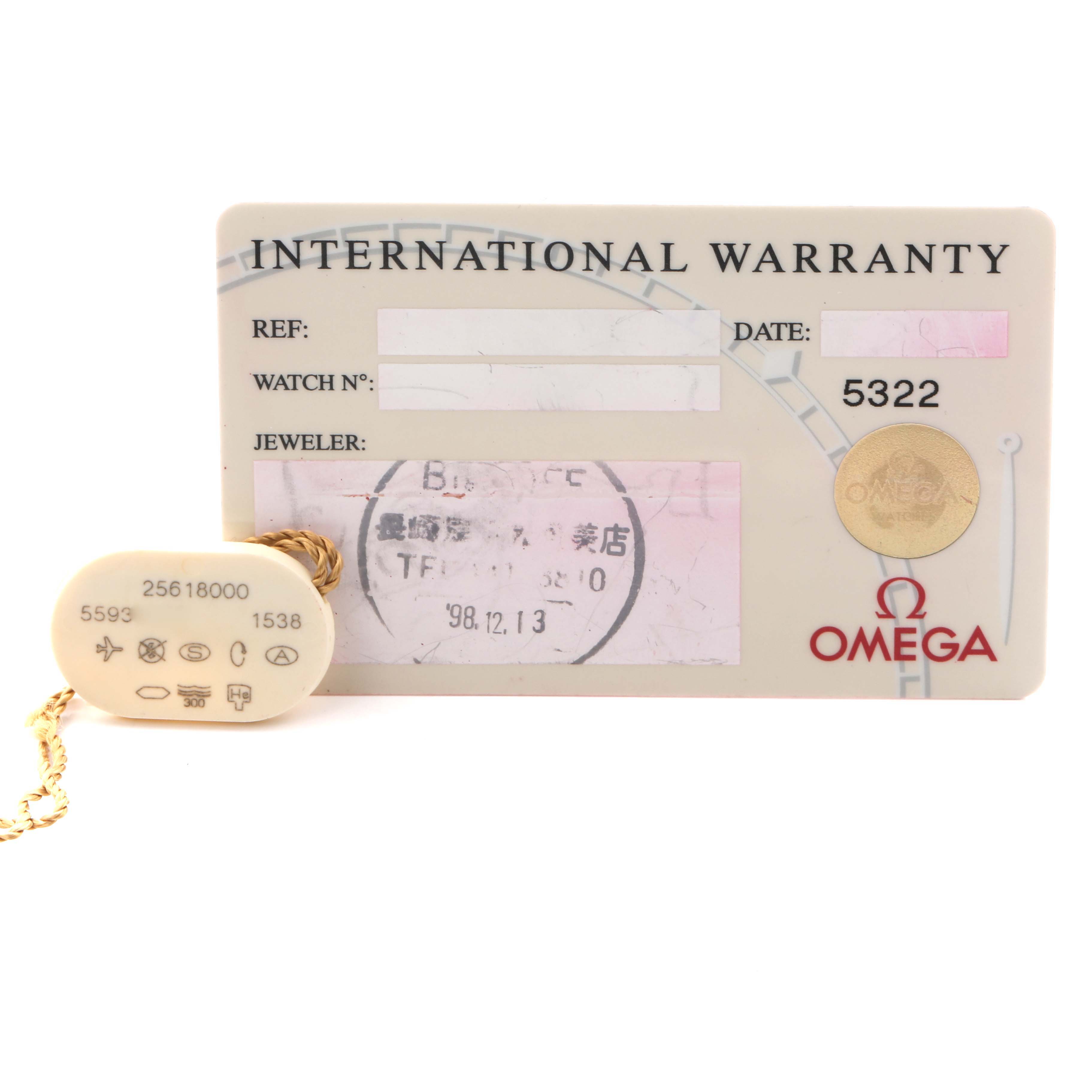 The image shows an Omega Seamaster 2561.80.00 Men's Stainless Steel Blue Dial 2561.80.00 Men's Stainless Steel Blue Dial international warranty card and a tag accessory, presented from a top view.