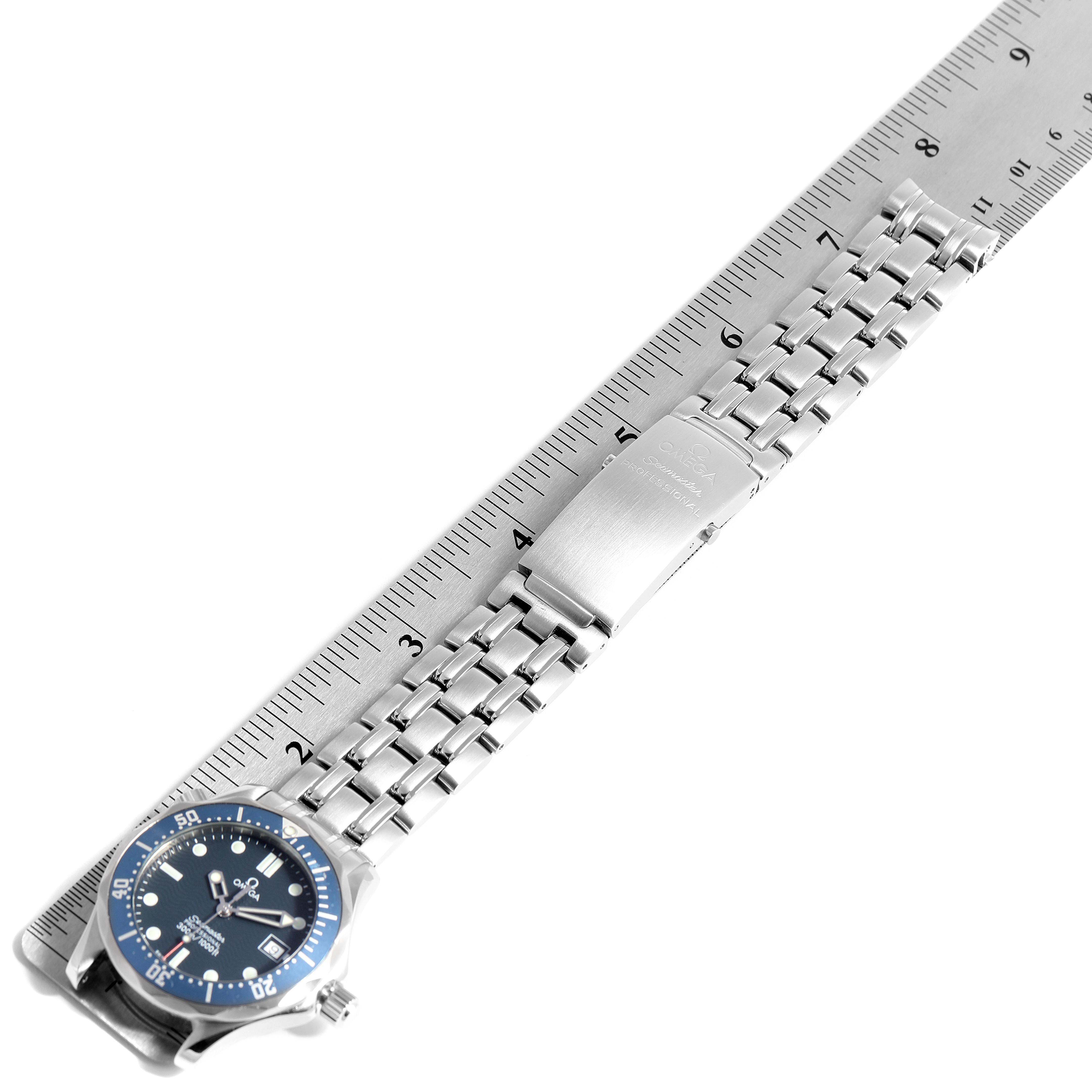 The image shows an Omega Seamaster 2561.80.00 Men
s Stainless Steel Blue Dial 2561.80.00 Men
s Stainless Steel Blue Dial watch laid flat on a ruler, displaying the face, bracelet, and clasp.