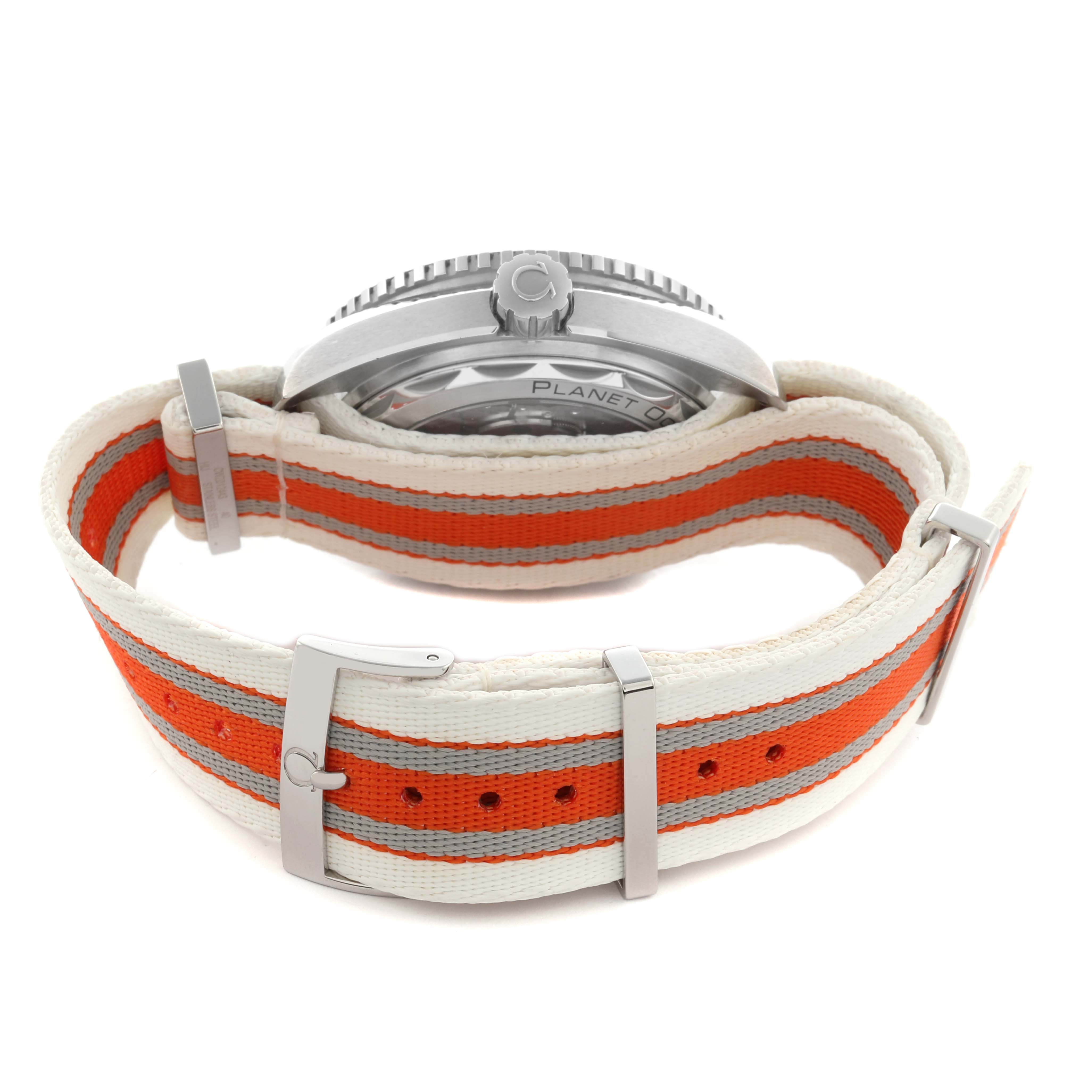 The image shows the side profile of an Omega Planet Ocean 215.32.44.21.04.001 Men
s Stainless Steel White Dial 215.32.44.21.04.001 Men
s Stainless Steel White Dial watch, highlighting its case back and striped fabric strap.
